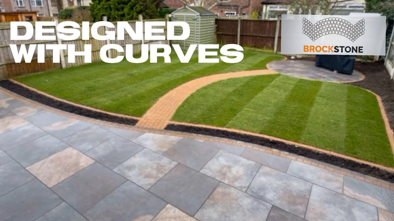 Curved block paved pathway through a landscaped front garden