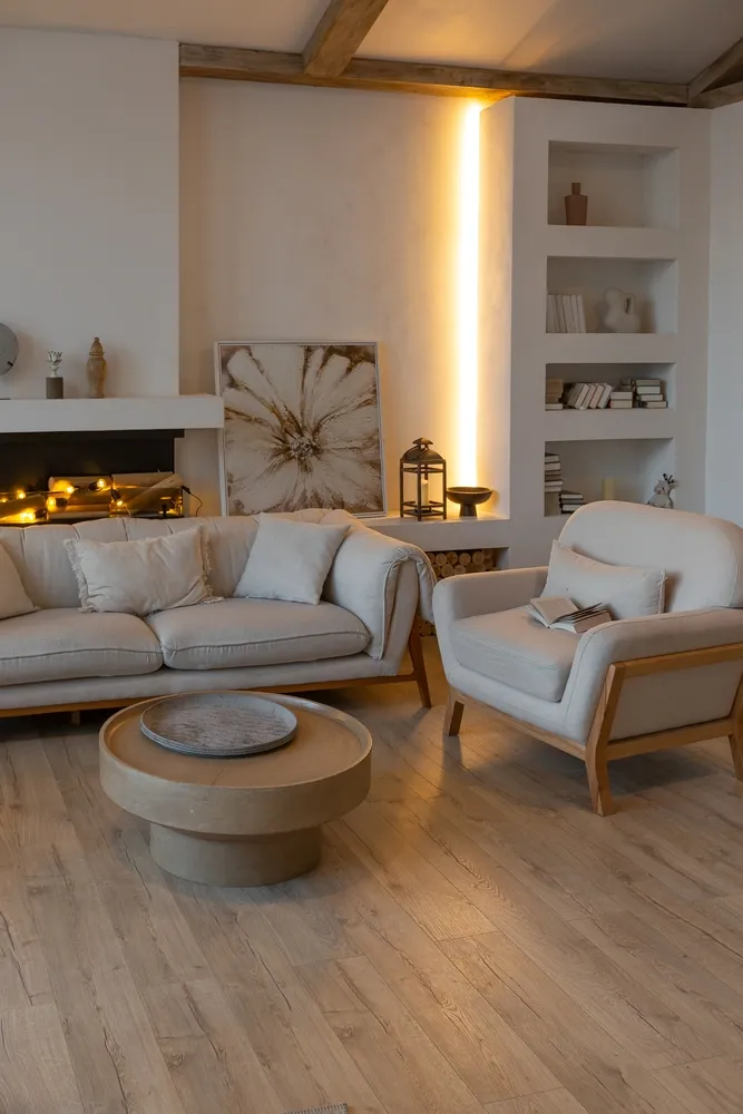 Cozy finished basement with exposed beams, fireplace and built-in shelving
