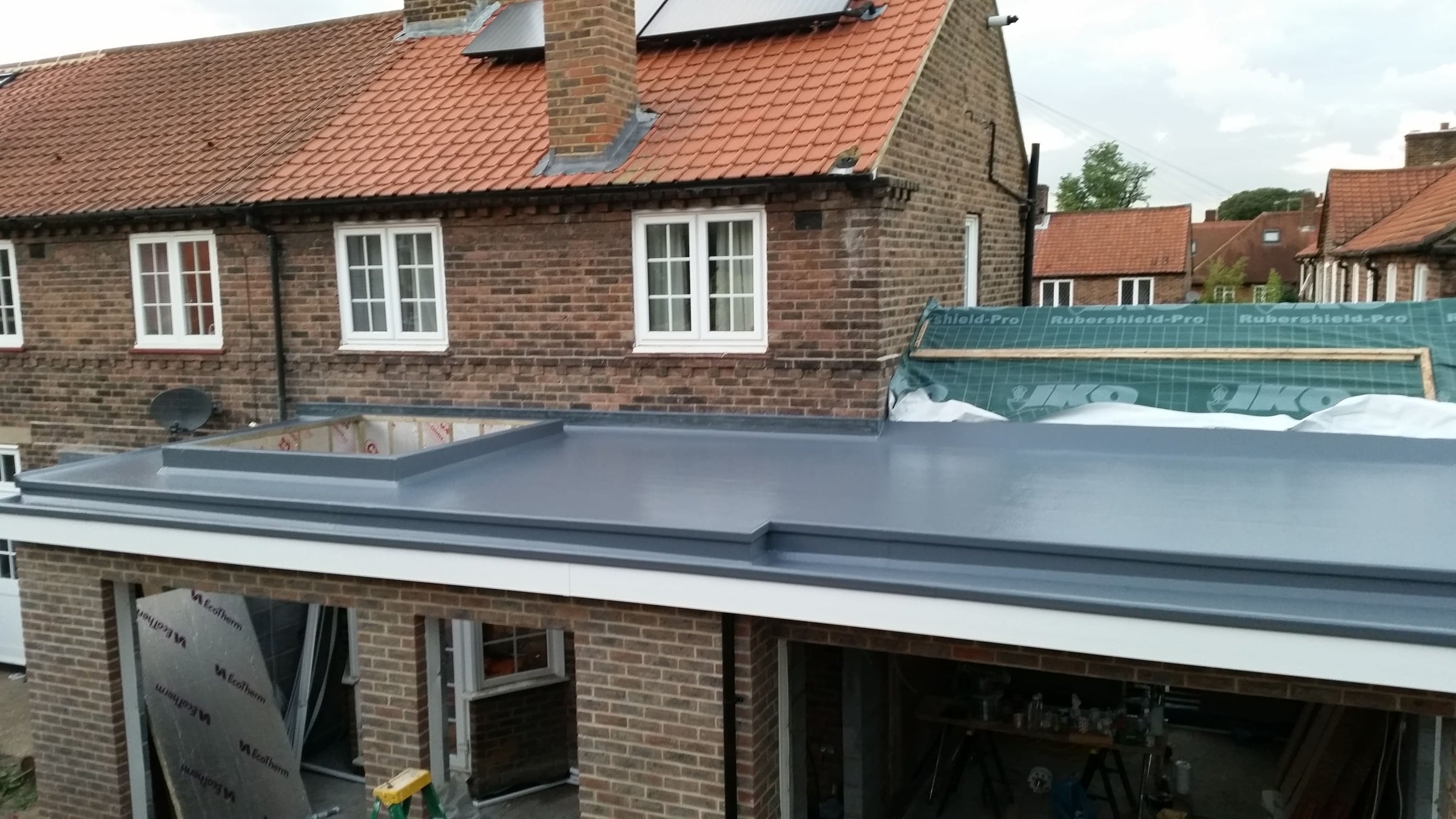 Flat roof being repaired on a UK house extension