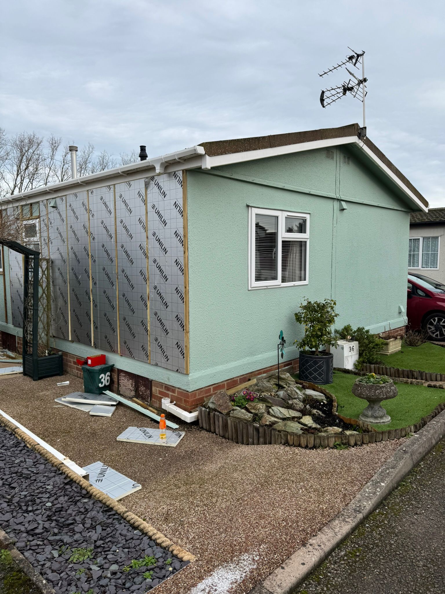 Green park home with Unilin insulation boards partially fitted around windows