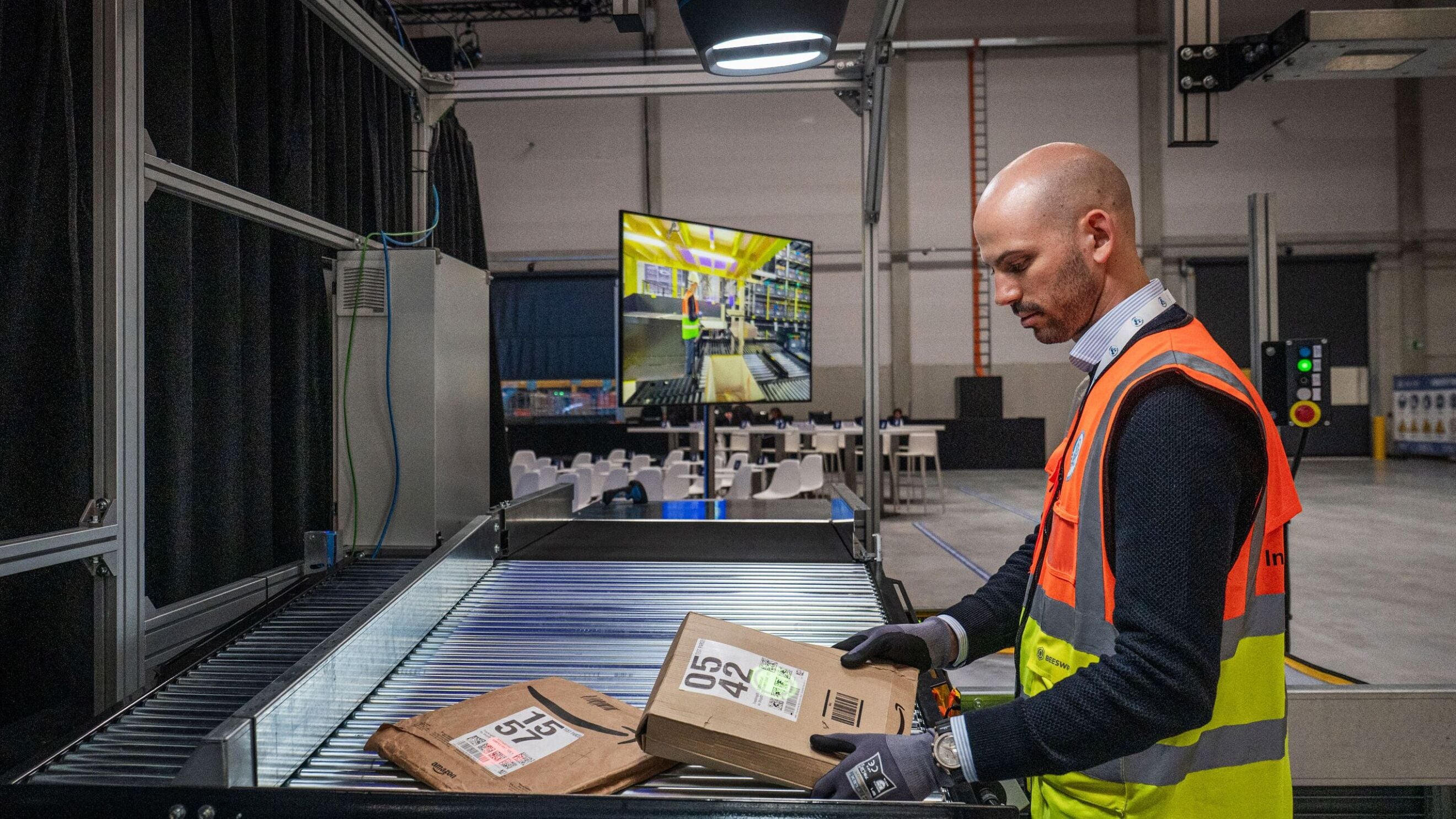 Workers sorting packages on a conveyor belt in a distribution centre