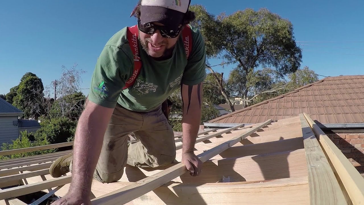 Roofer installing roof battens on a UK house