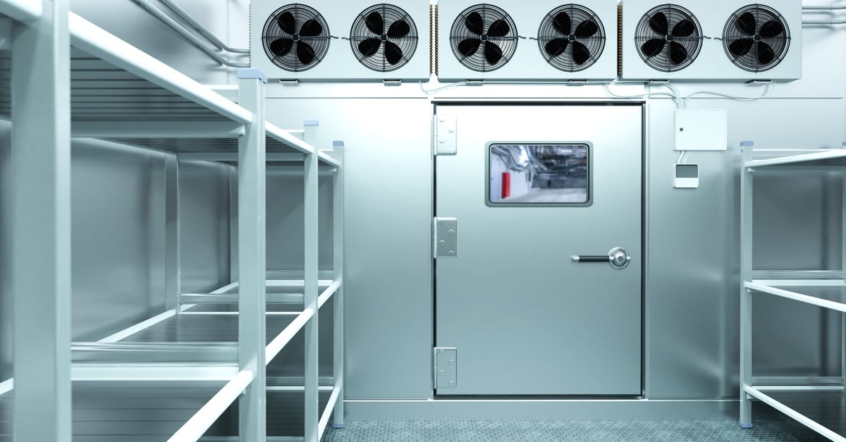 Commercial walk-in cooler interior with stainless steel shelving