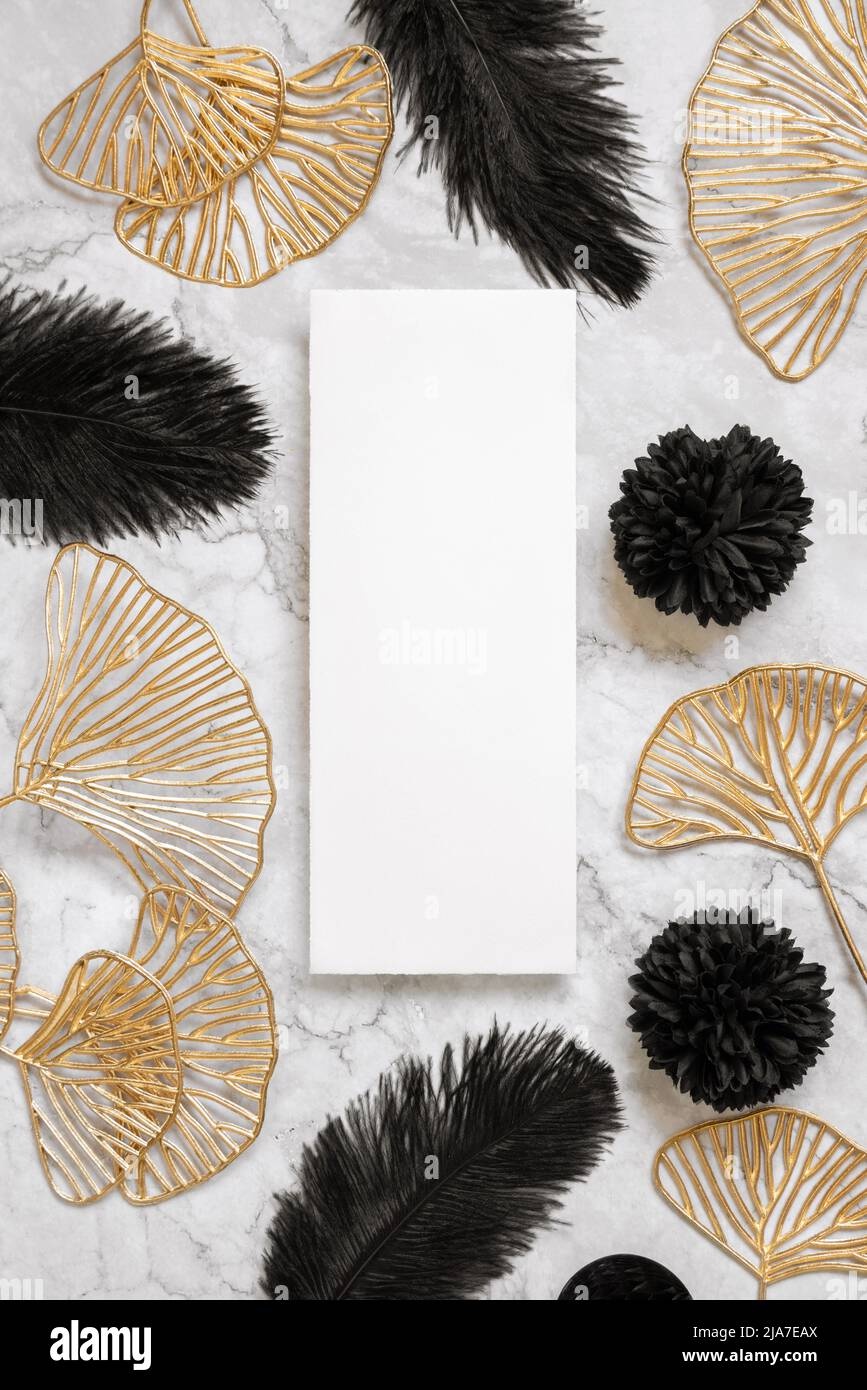 Elegant wedding details with rings and invitation on marble