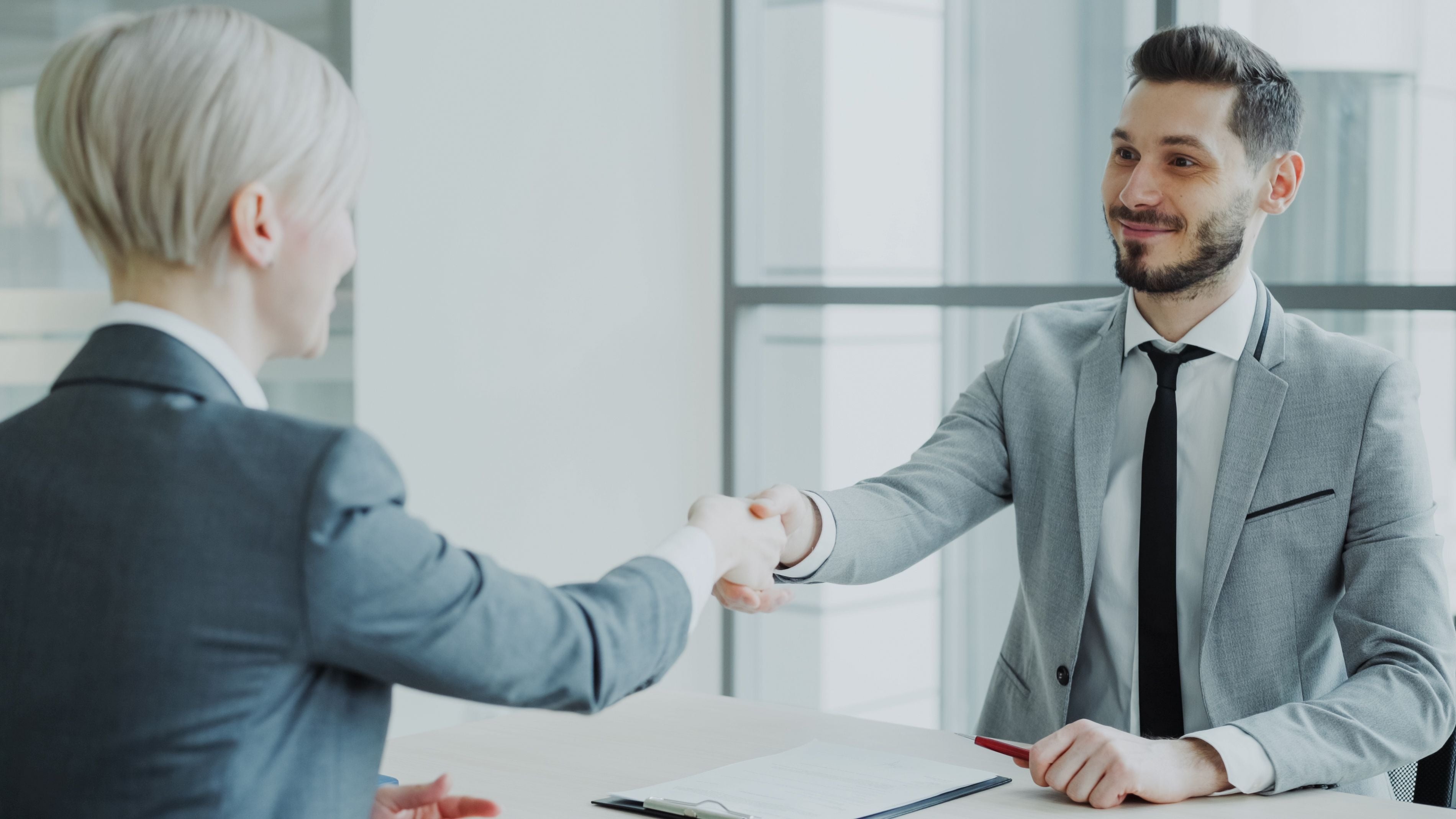 Professional handshake in a modern Hong Kong office