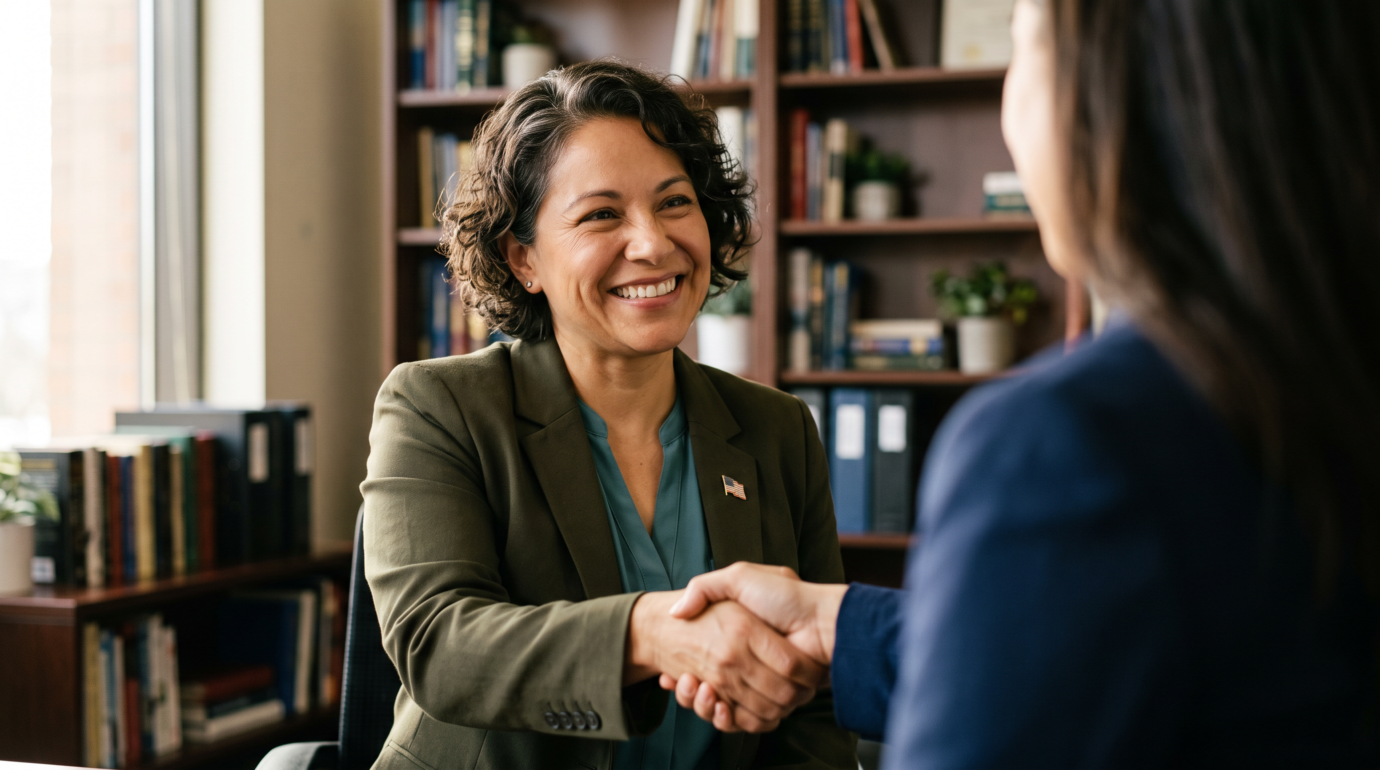 A woman military veteran shaking hands to seal an agreement after a consultation