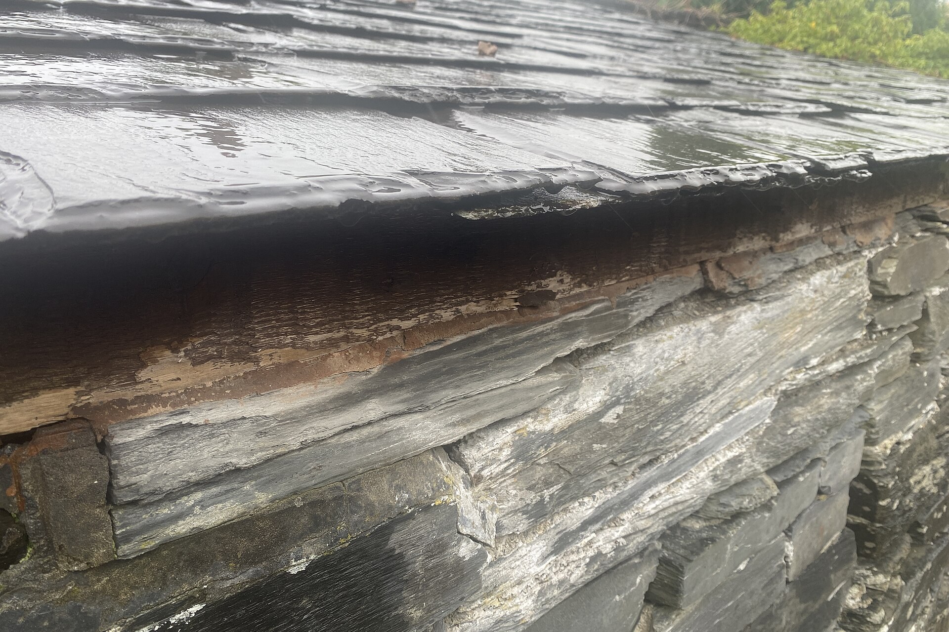Close-up of a worn slate roof edge