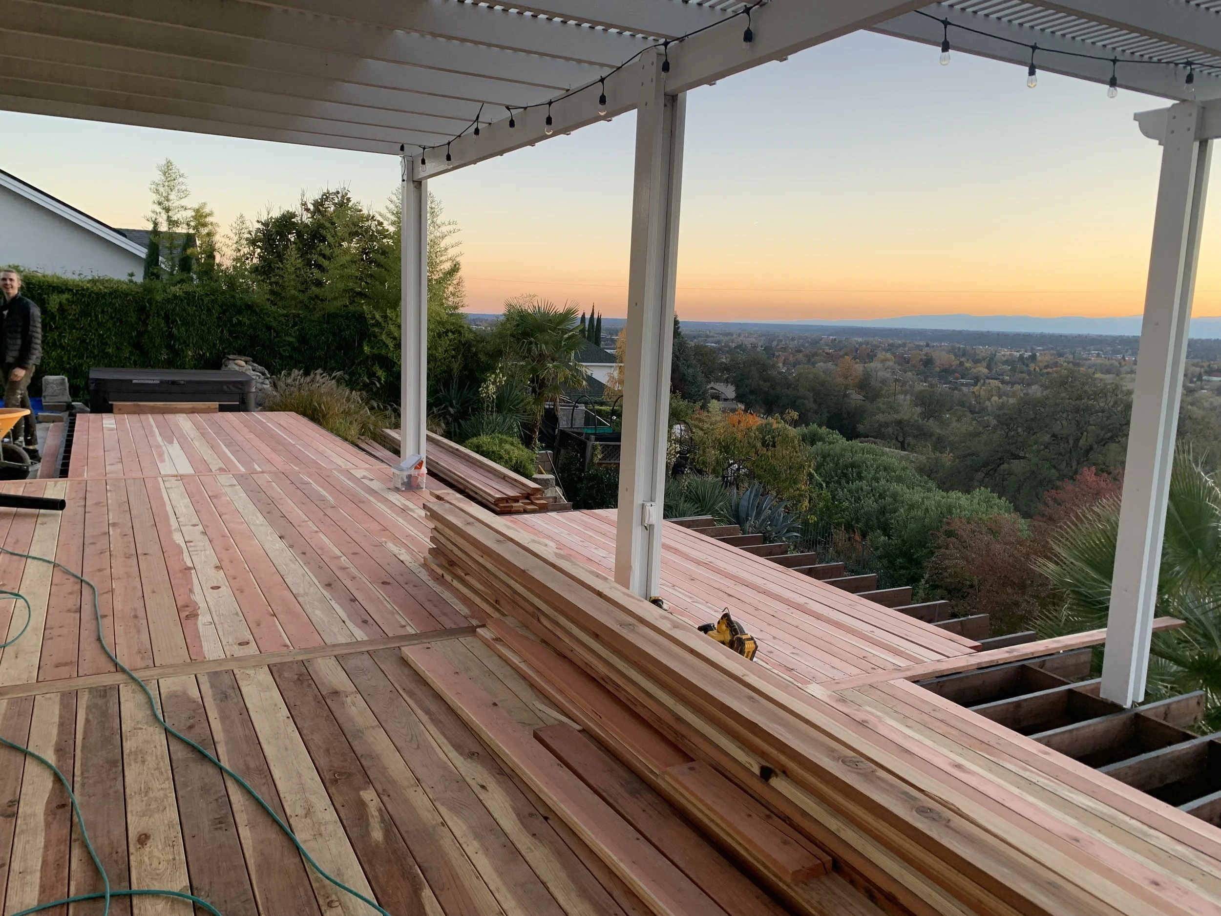Deck construction on hillside with beautiful sunset view