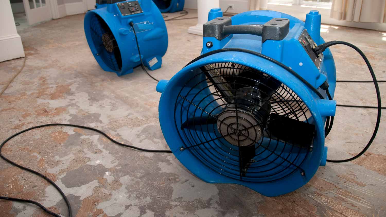 Professional water damage restoration equipment including industrial fans and dehumidifiers
