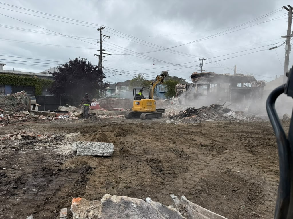 Excavator Demolishing Structure