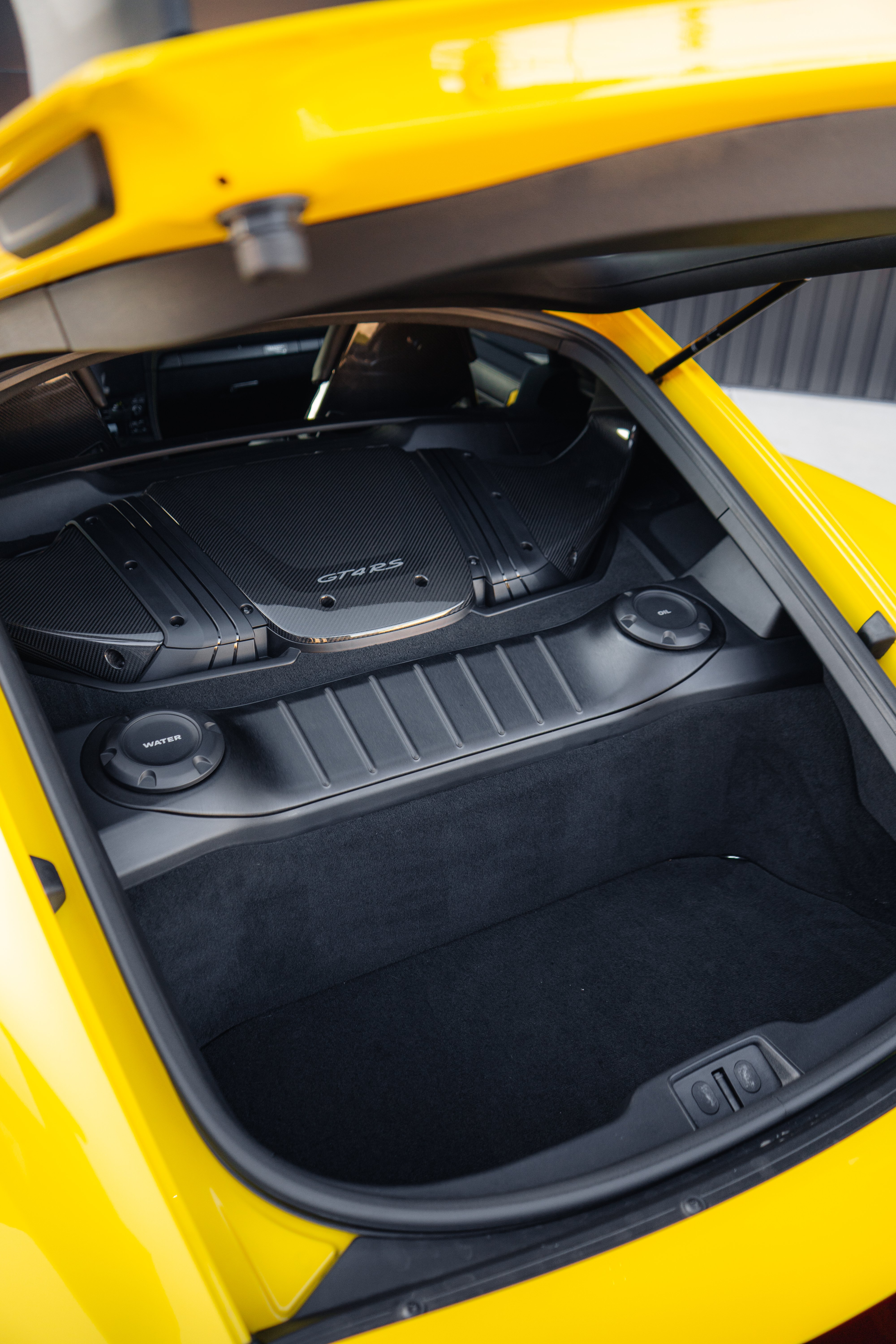 2023 Porsche GT4 RS passenger side profile in Racing Yellow