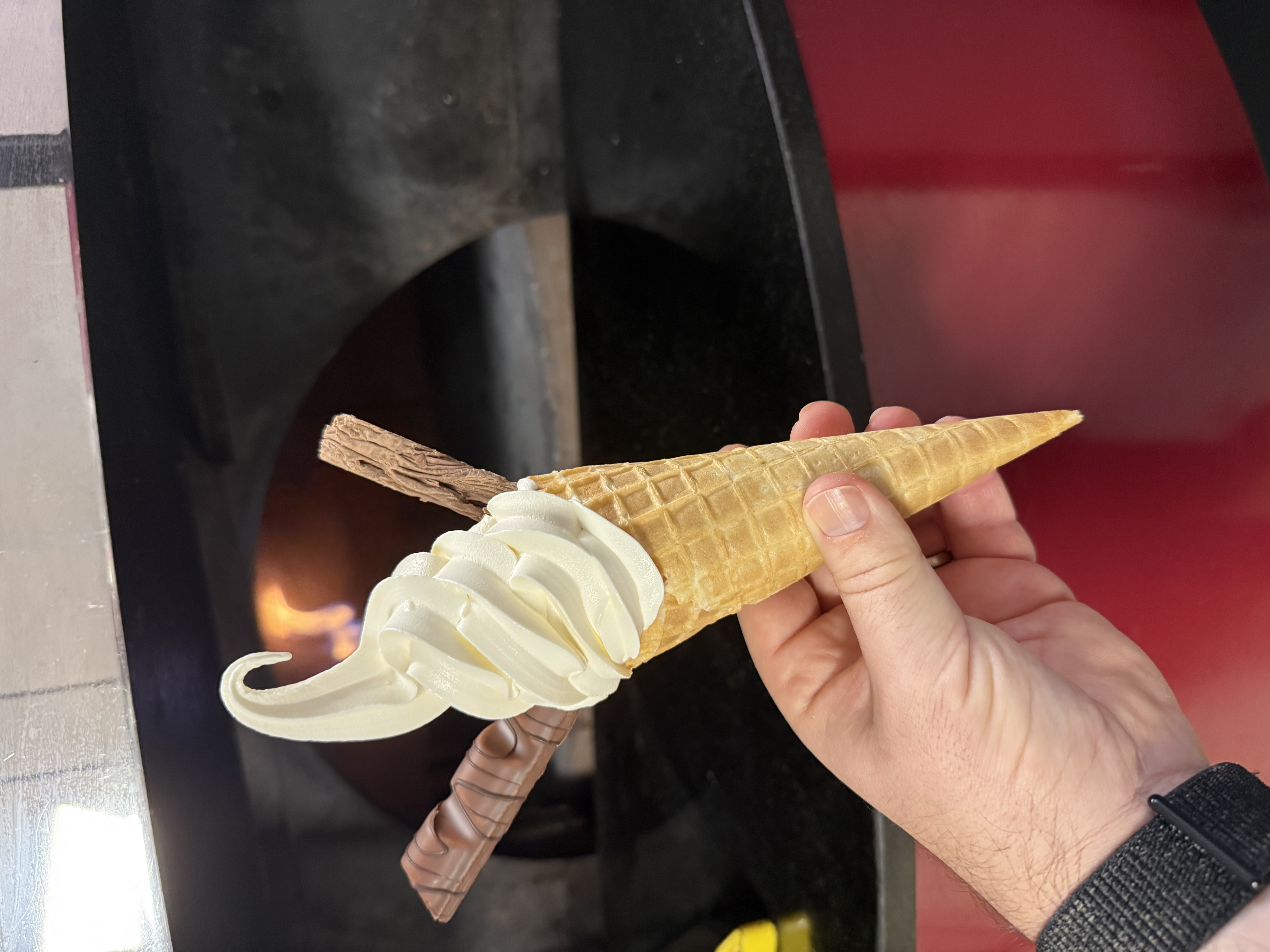 Classic soft serve ice cream cone with chocolate flake