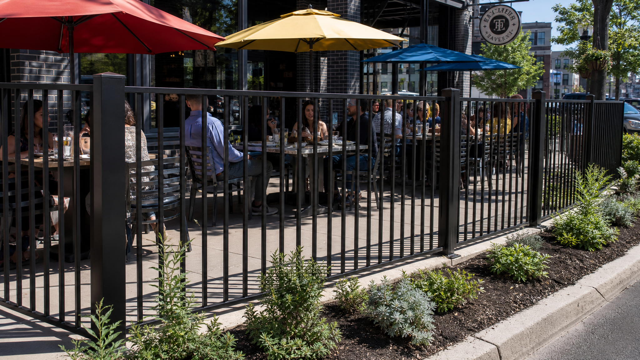 C200 Commercial flat-top welded steel fence enclosing an outdoor dining patio