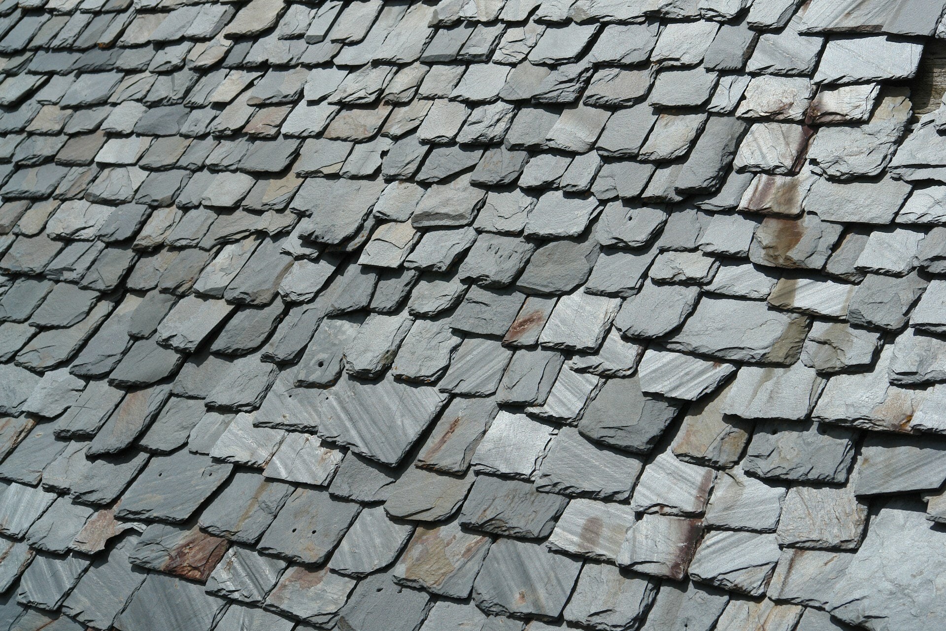 Weathered slate roof with slipped slates needing repair