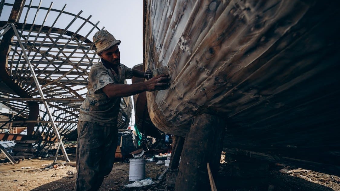 Skilled marine craftsman performing composite boat repair