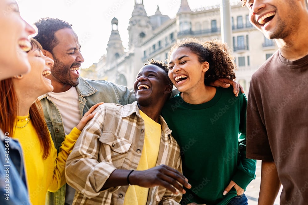 Diverse group of young travelers laughing together on an adventure