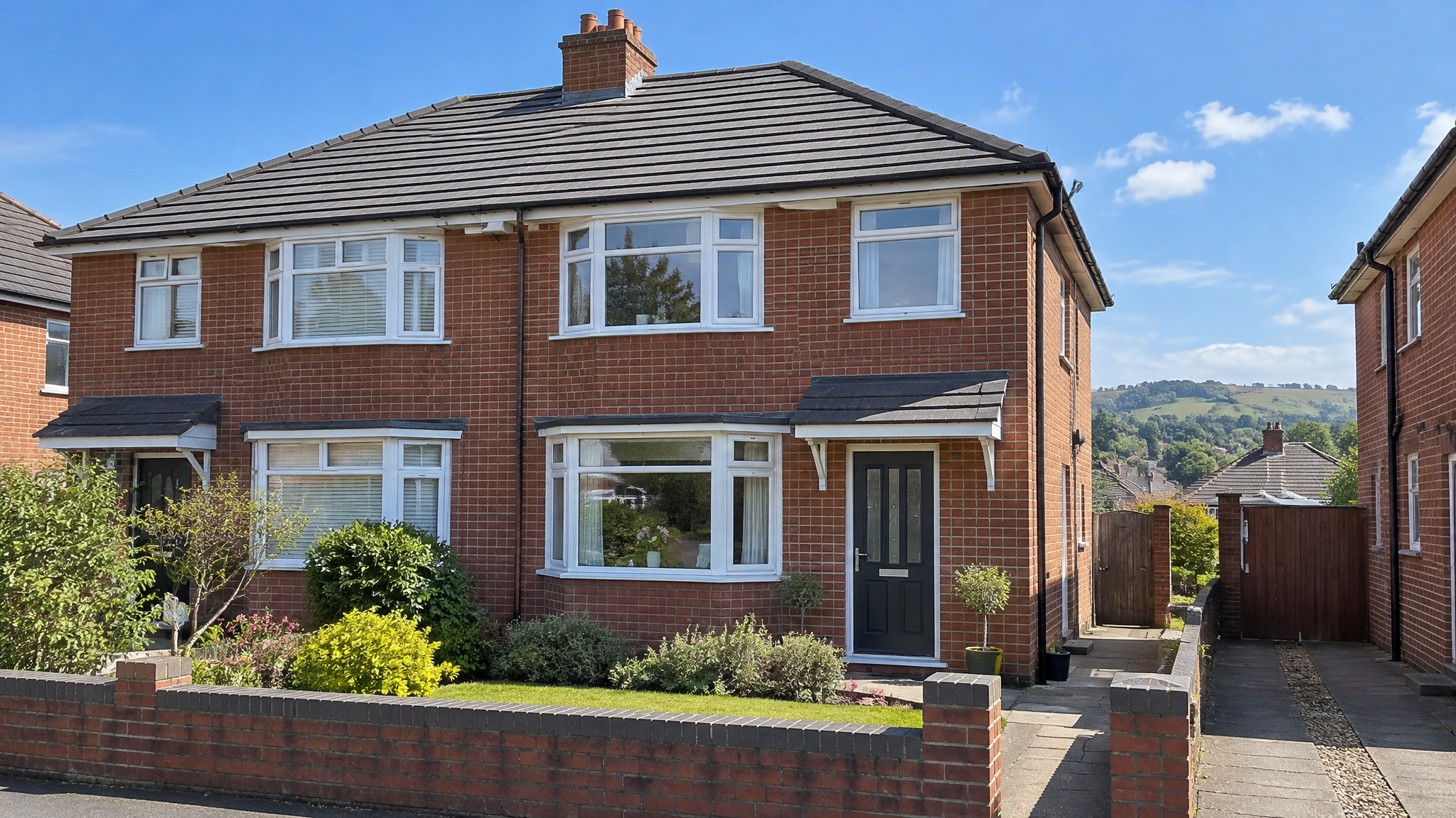 New tiled roof on a red-brick semi-detached house in South Wales