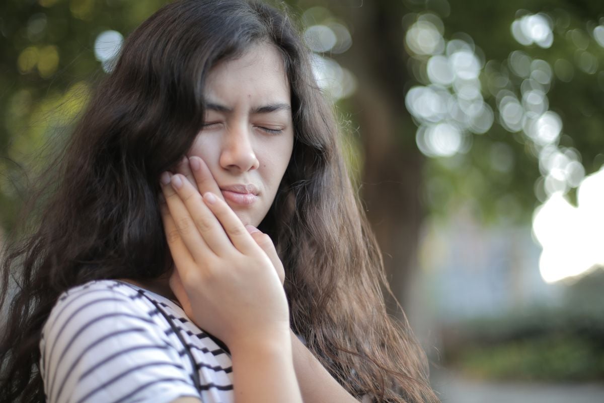 Dental professional providing emergency help for severe toothache assessment