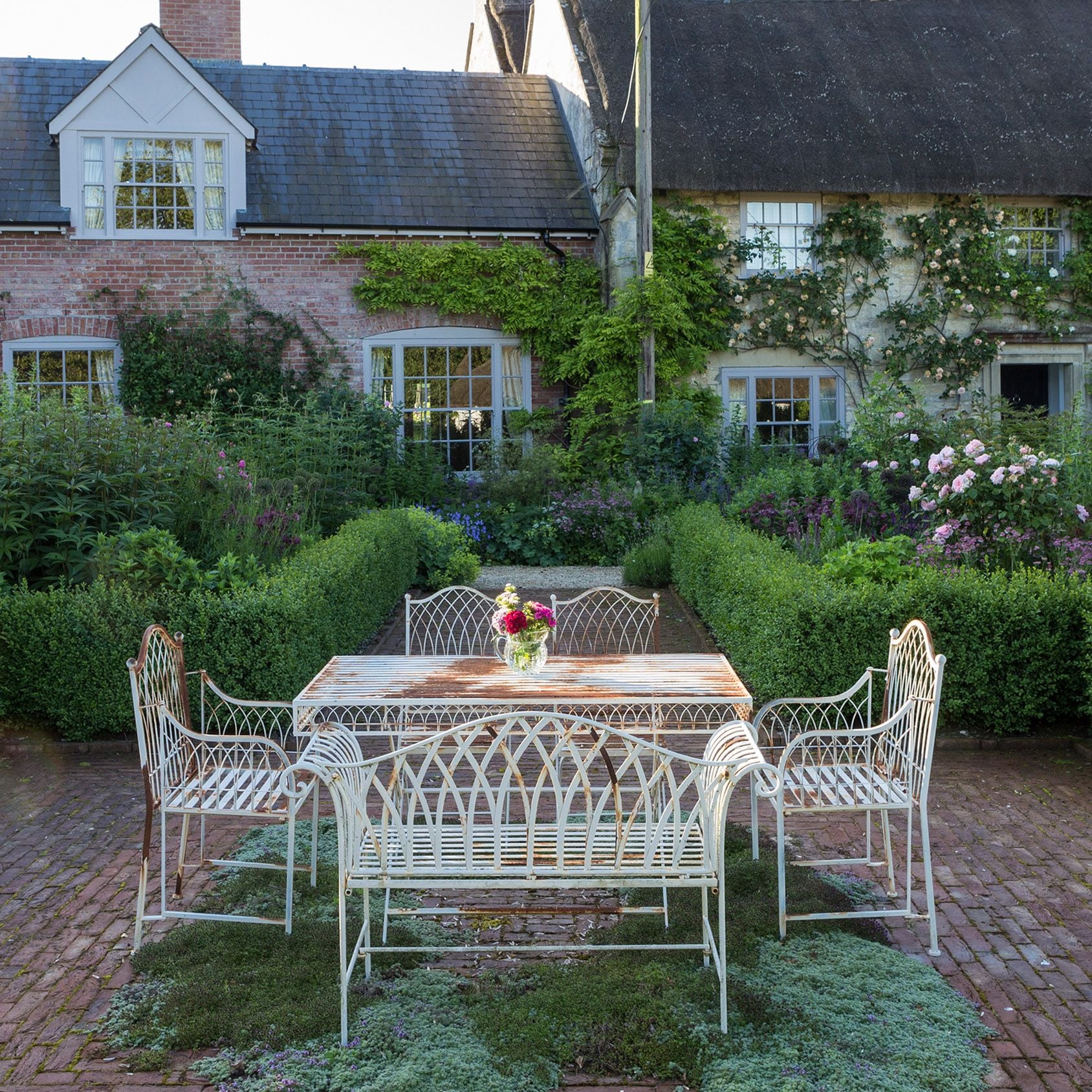 Traditional English back garden with patio and flower beds