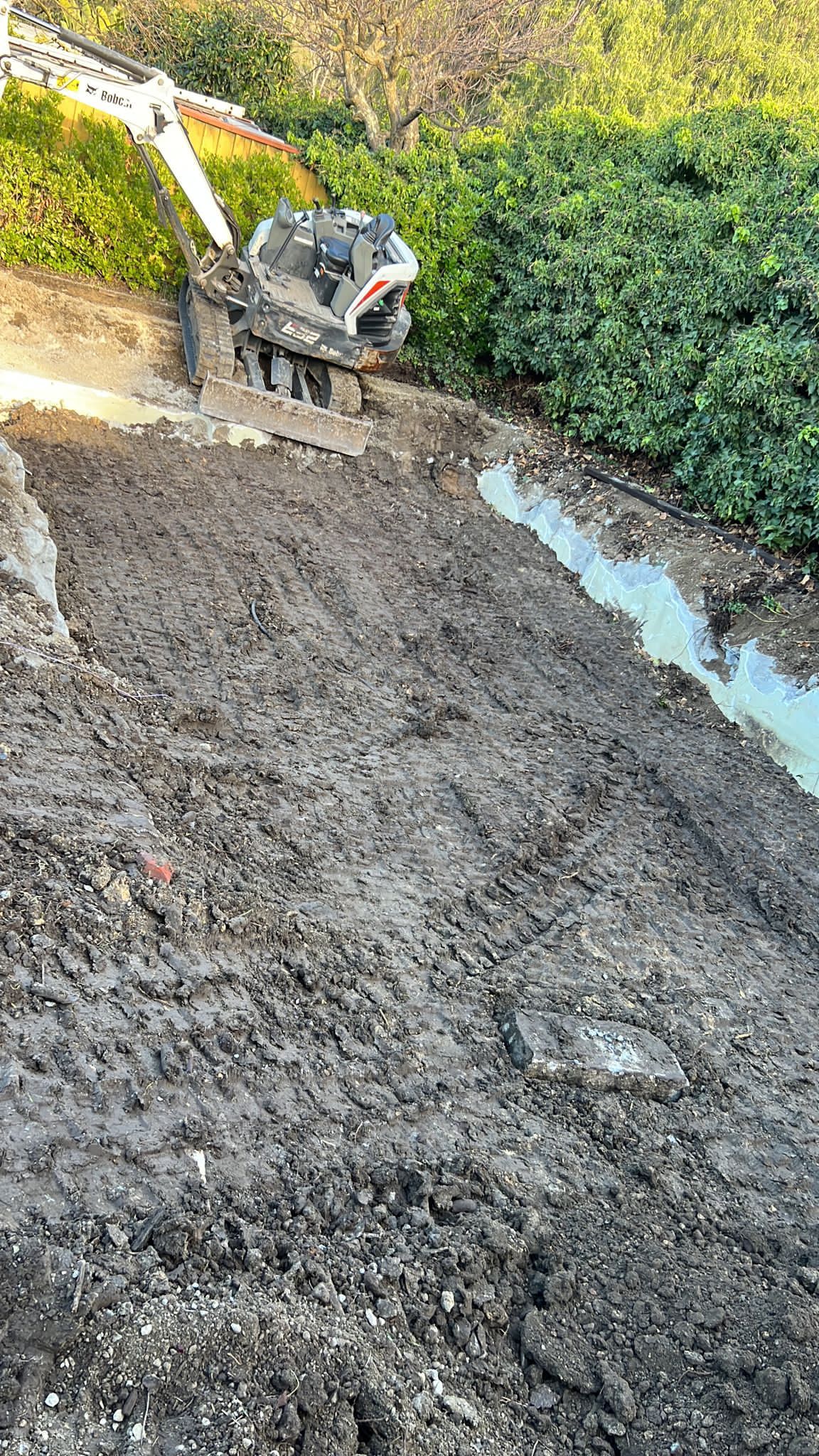 Bobcat Backfilling Pool Area
