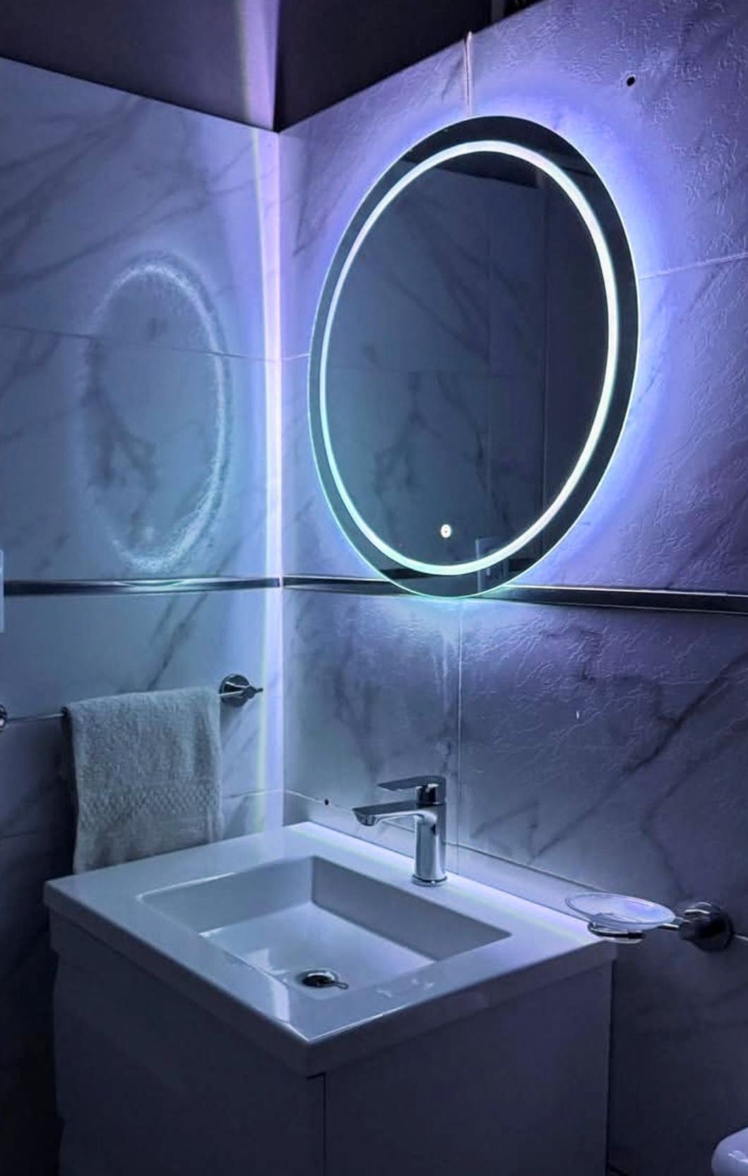 Espejo redondo en baño con luz violeta - LuminaCrystal