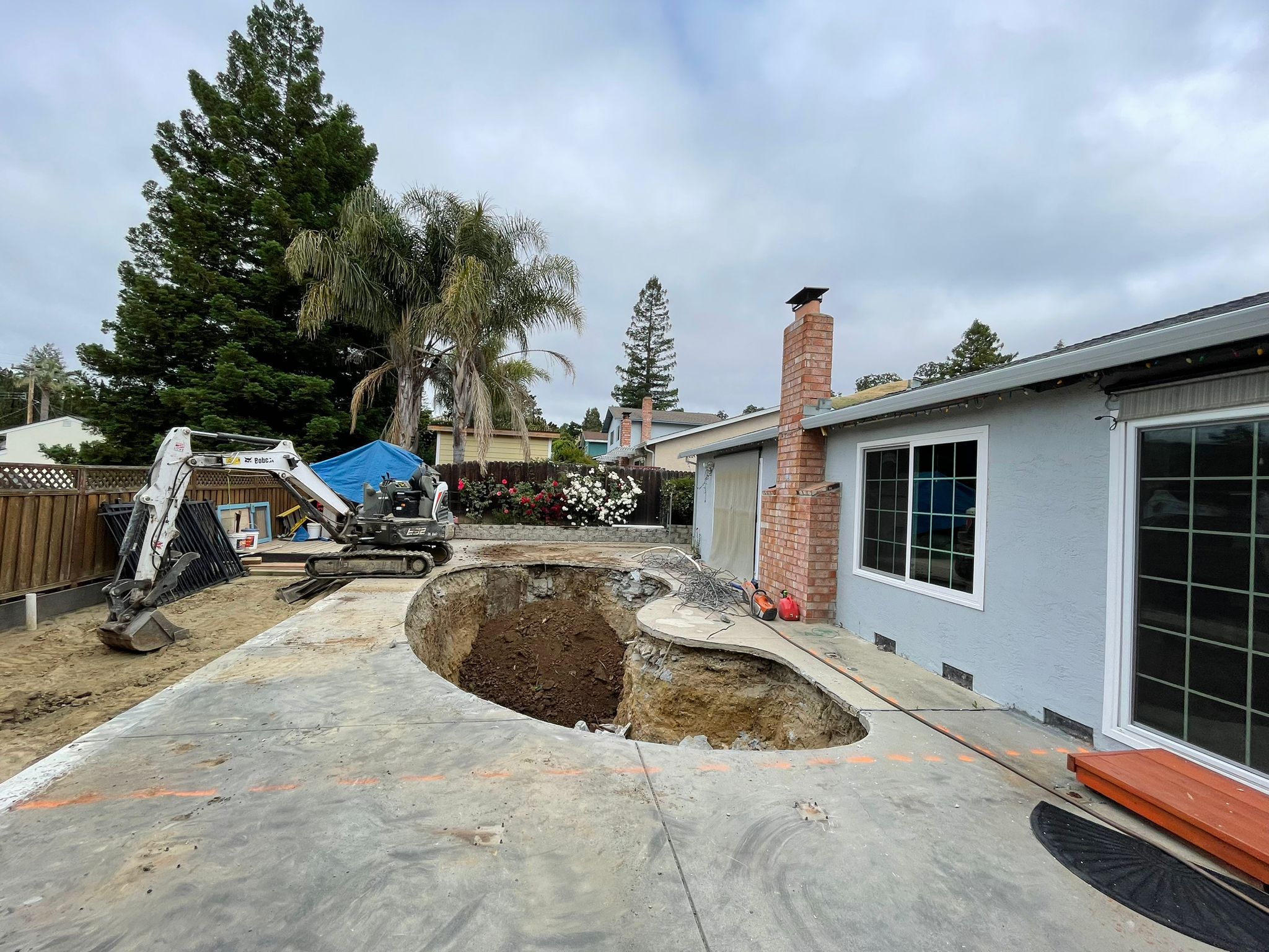 Excavator Demolishing Pool