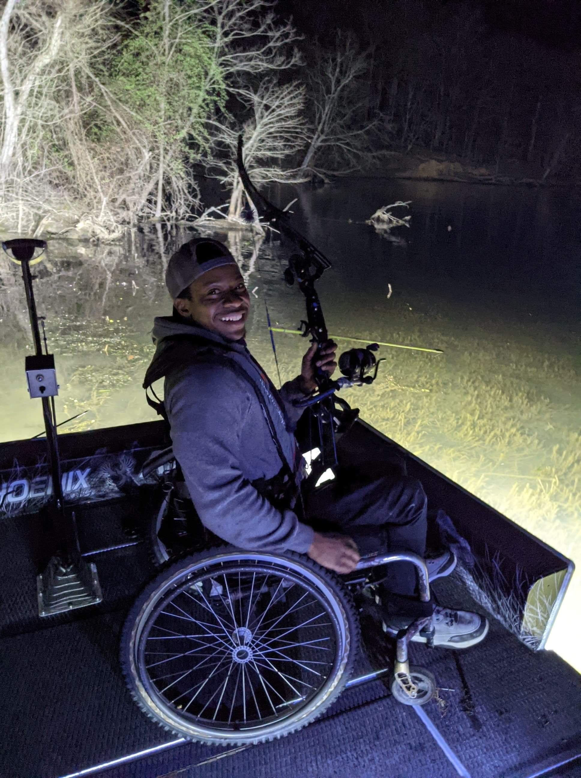 Joshua bowfishing from a Phoenix boat at night