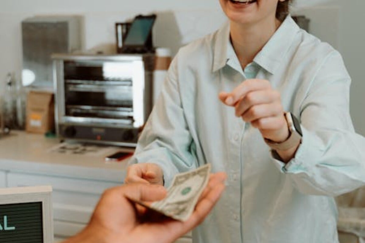 Happy customer receiving cash for their car in Brisbane