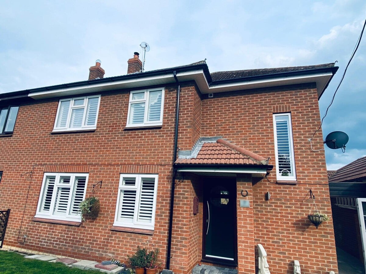 Complete uPVC roofline with fascia, soffit and guttering on brick property