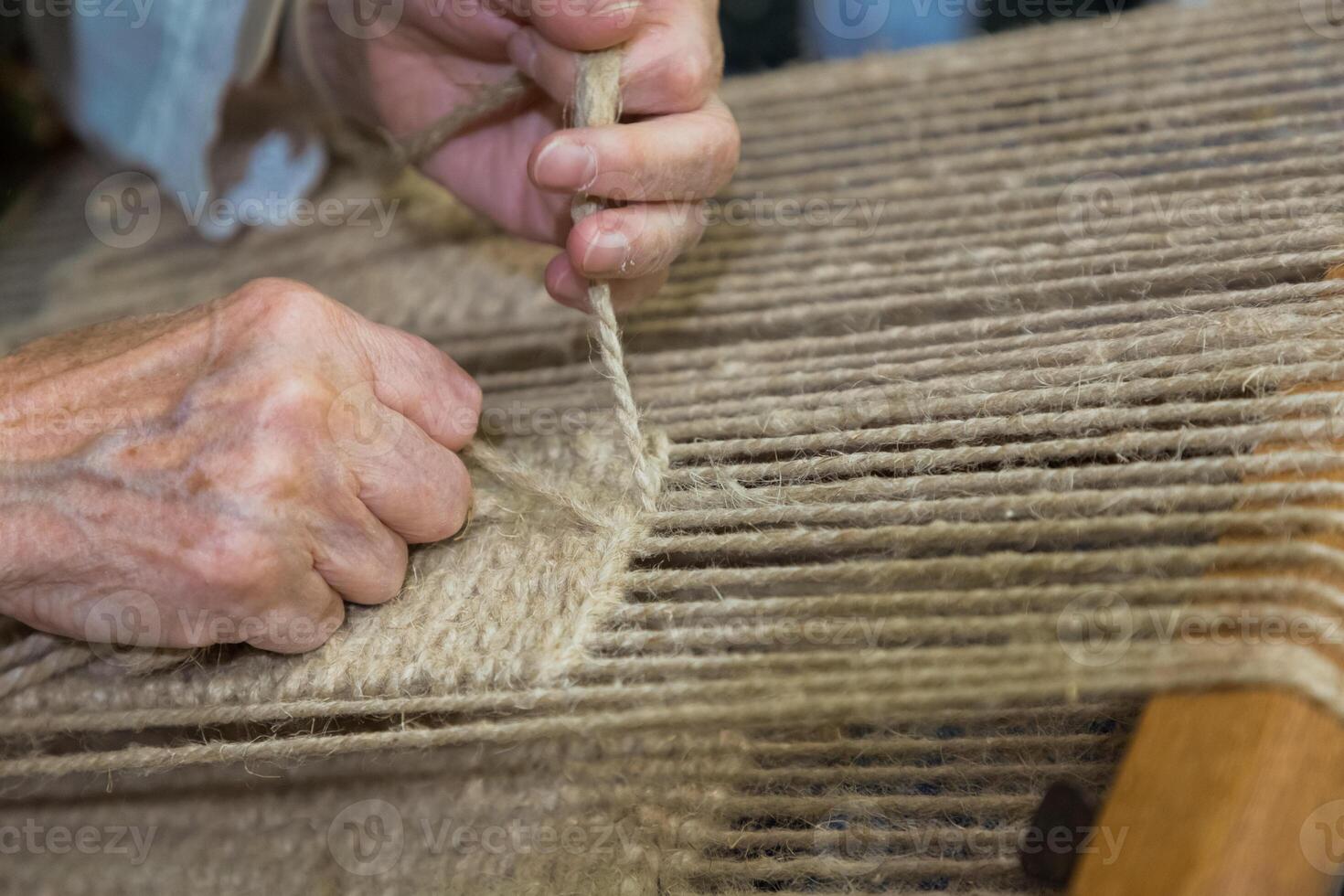 Artisan hands at work on traditional loom