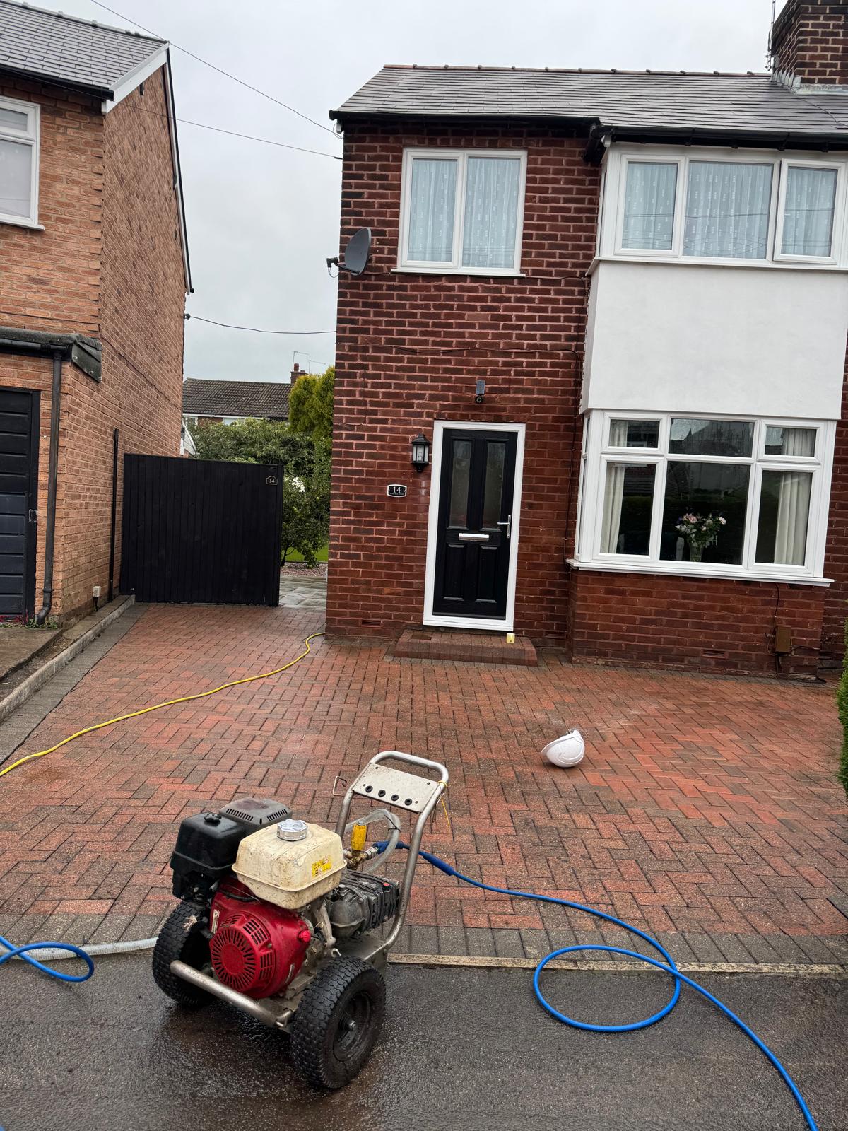 Herringbone brick driveway after cleaning - bricks restored to original colour