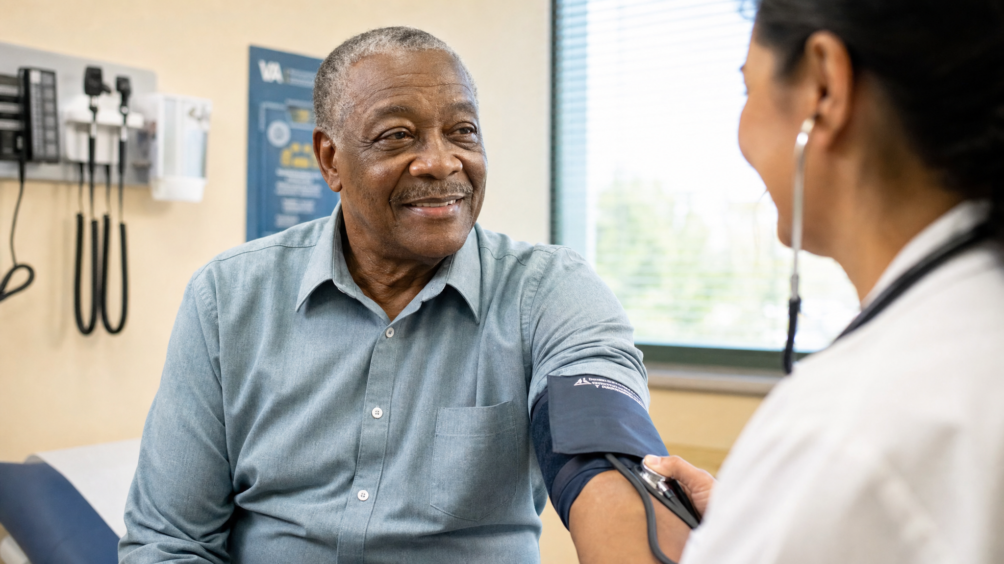 A senior Black male veteran having a warm checkup with a nurse at a VA clinic