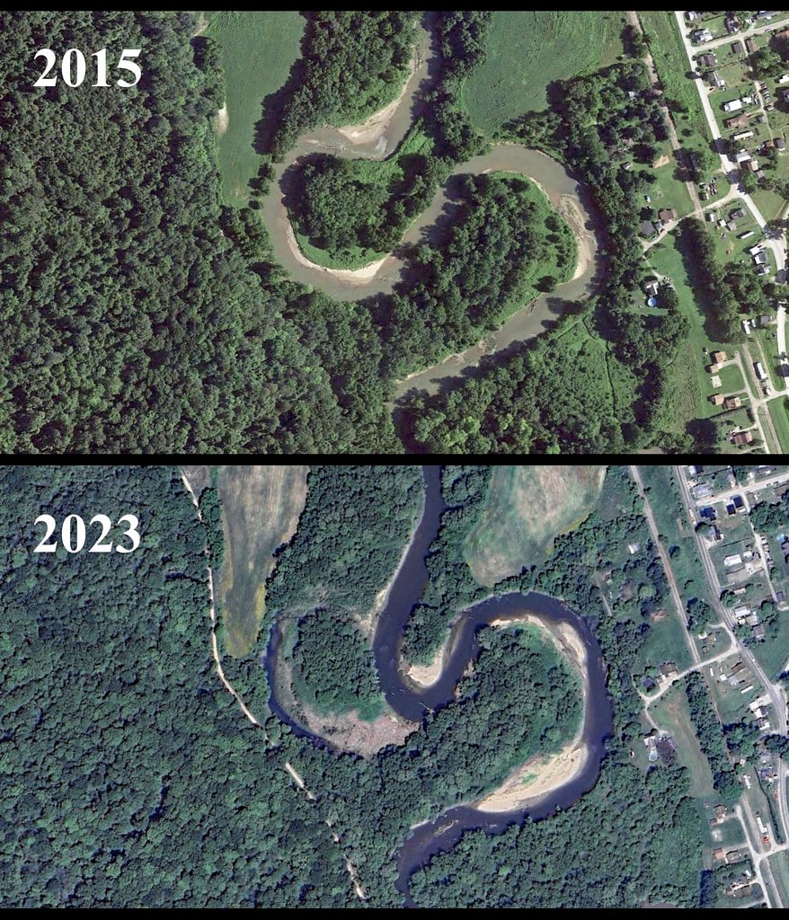 A crescent-shaped oxbow lake beside a winding river
