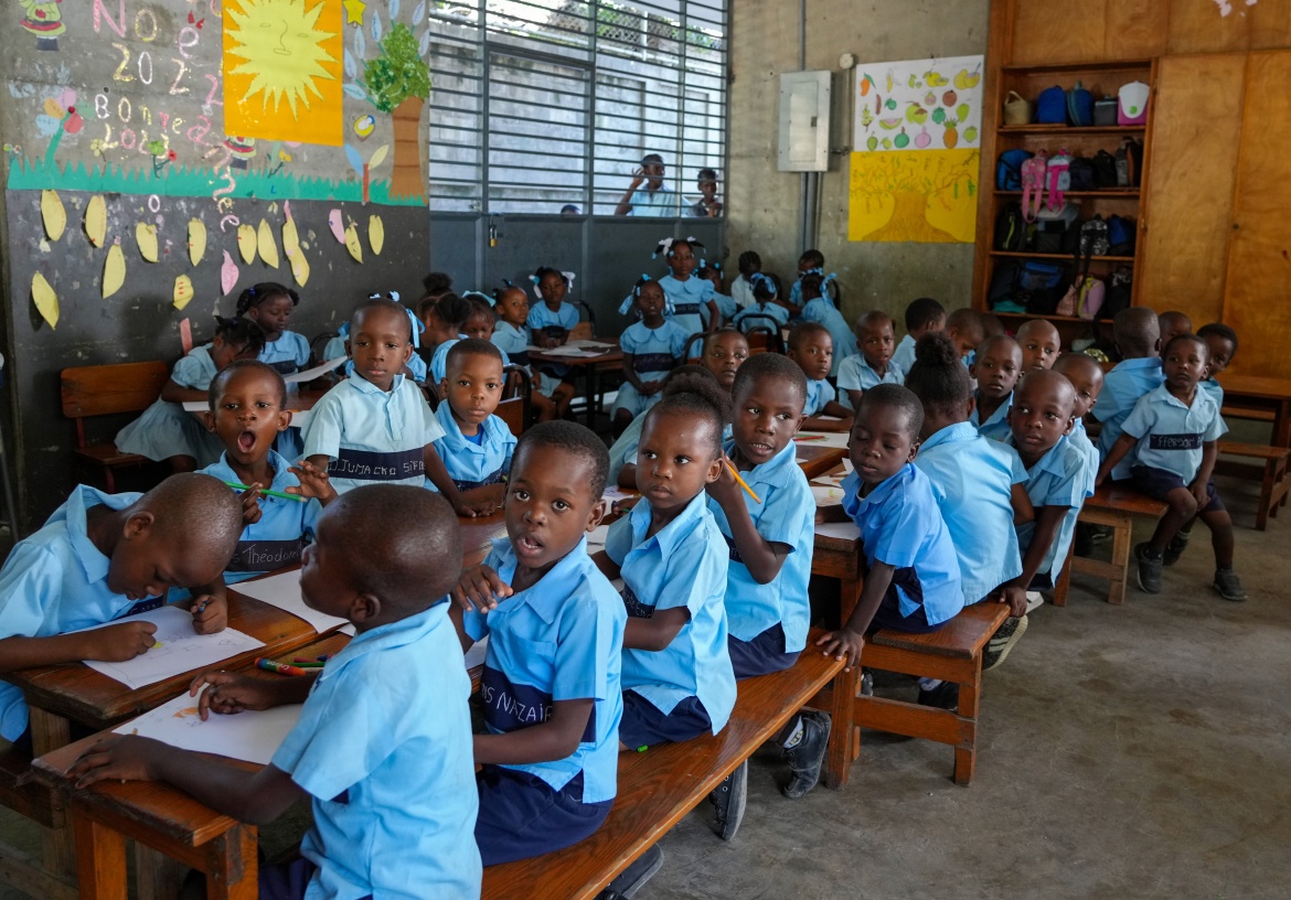 Children in Haiti with school supplies