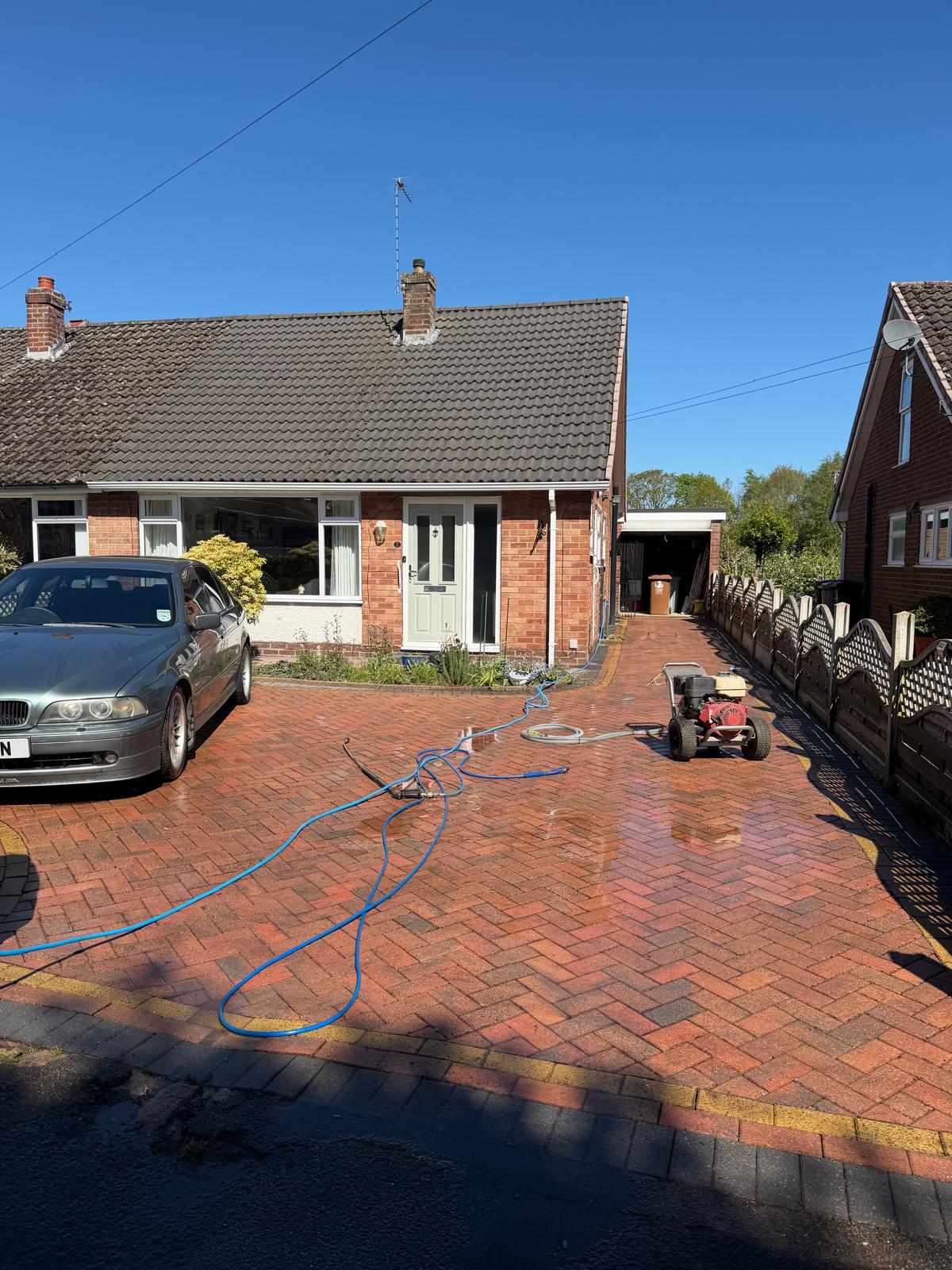 Patterned driveway before cleaning - visible dirt and weathering