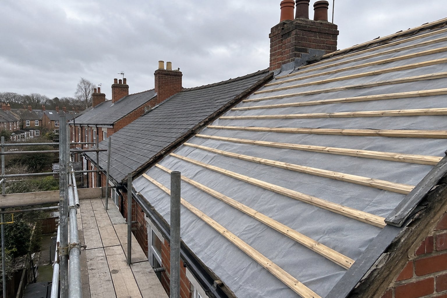 Terraced house roof being re-roofed with new membrane and battens