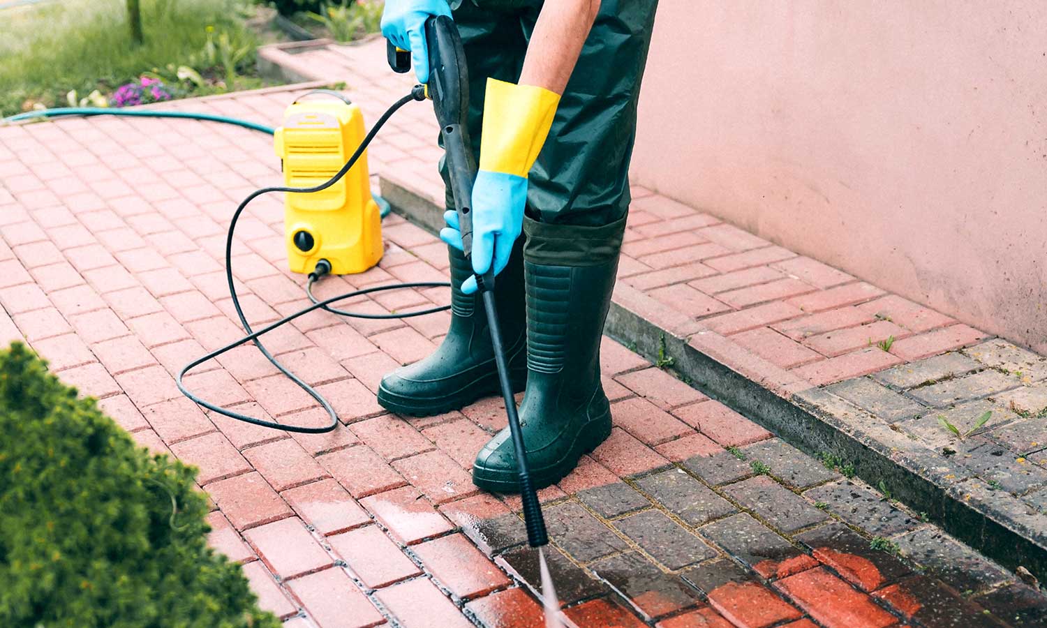 Professional sidewalk pressure washing with water spray