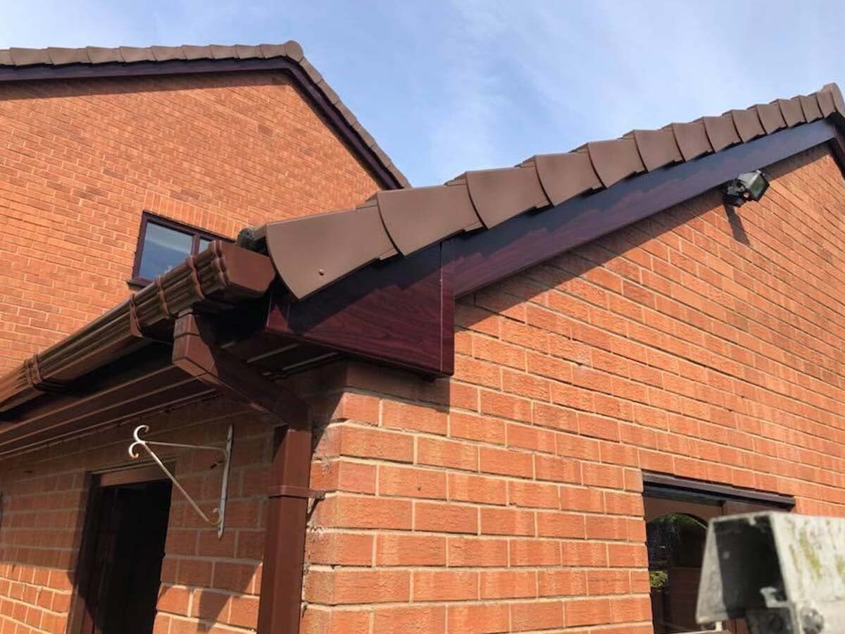 Dry verge caps installed along a gable end of a UK tiled roof
