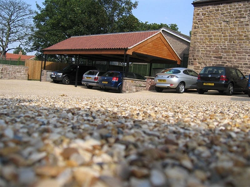 Large resin driveway with parked car