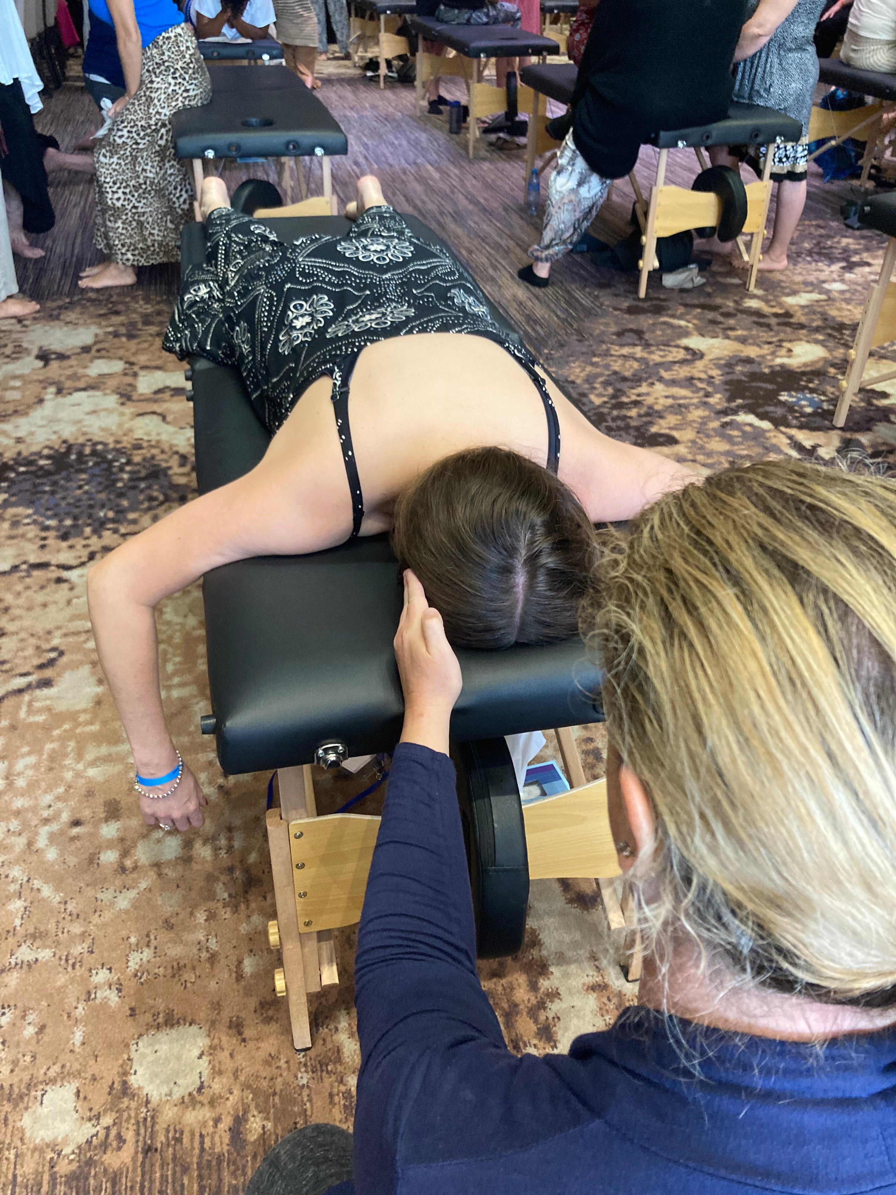 Close-up of gentle Spinal Flow light-touch technique during immersive training