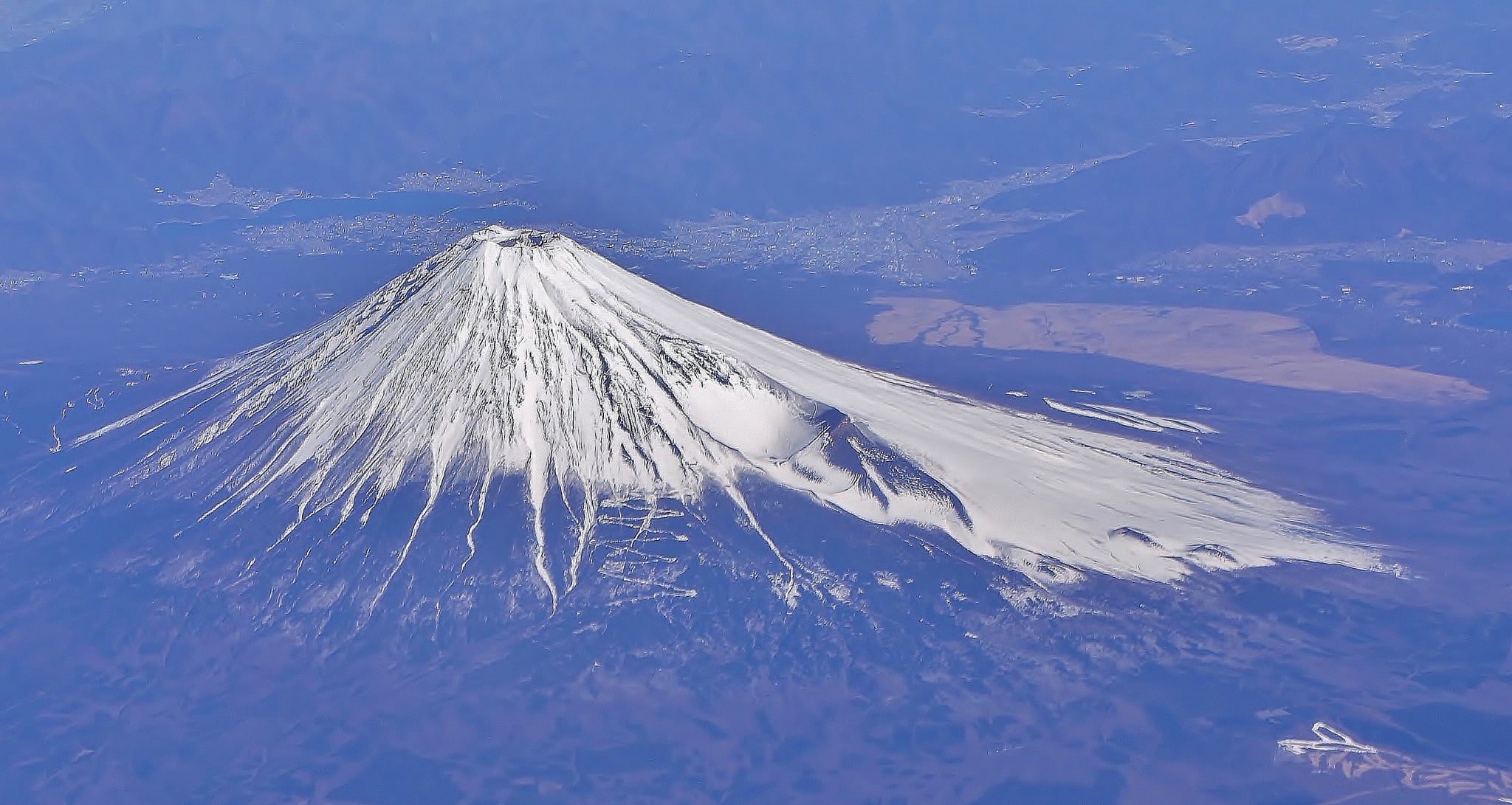 A symmetrical snow-capped volcanic cone