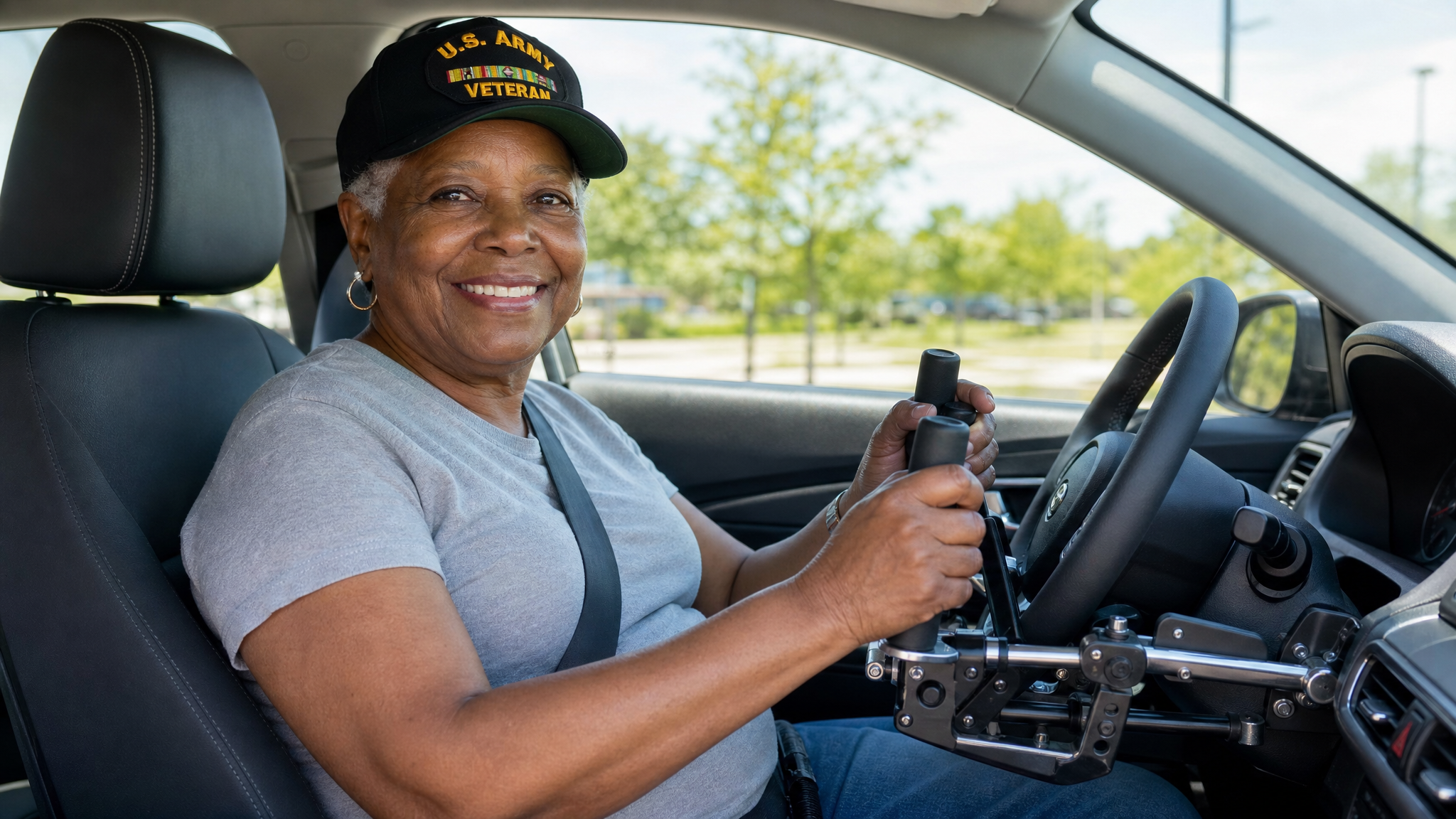 A senior African American female veteran driving with adaptive hand controls, smiling with restored independence