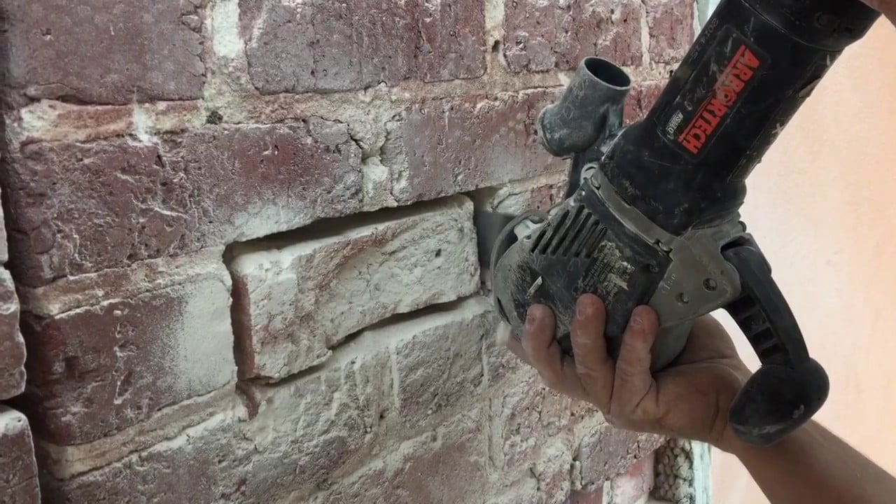 Brick wall being repointed with fresh mortar