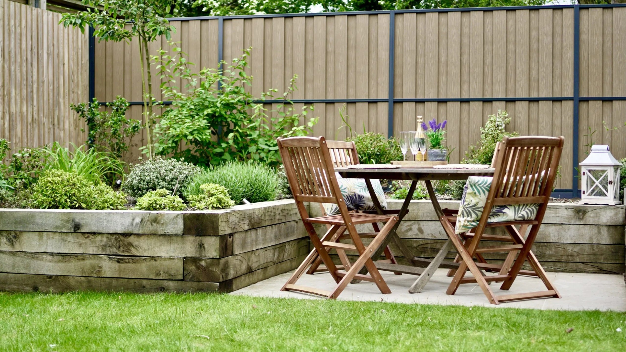 Garden with wooden panel fencing and green lawn