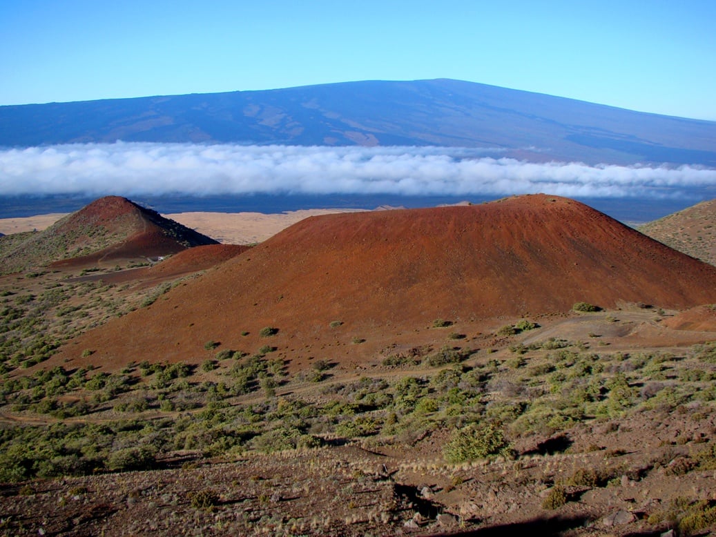 A broad gently sloping shield volcano with fluid lava flows