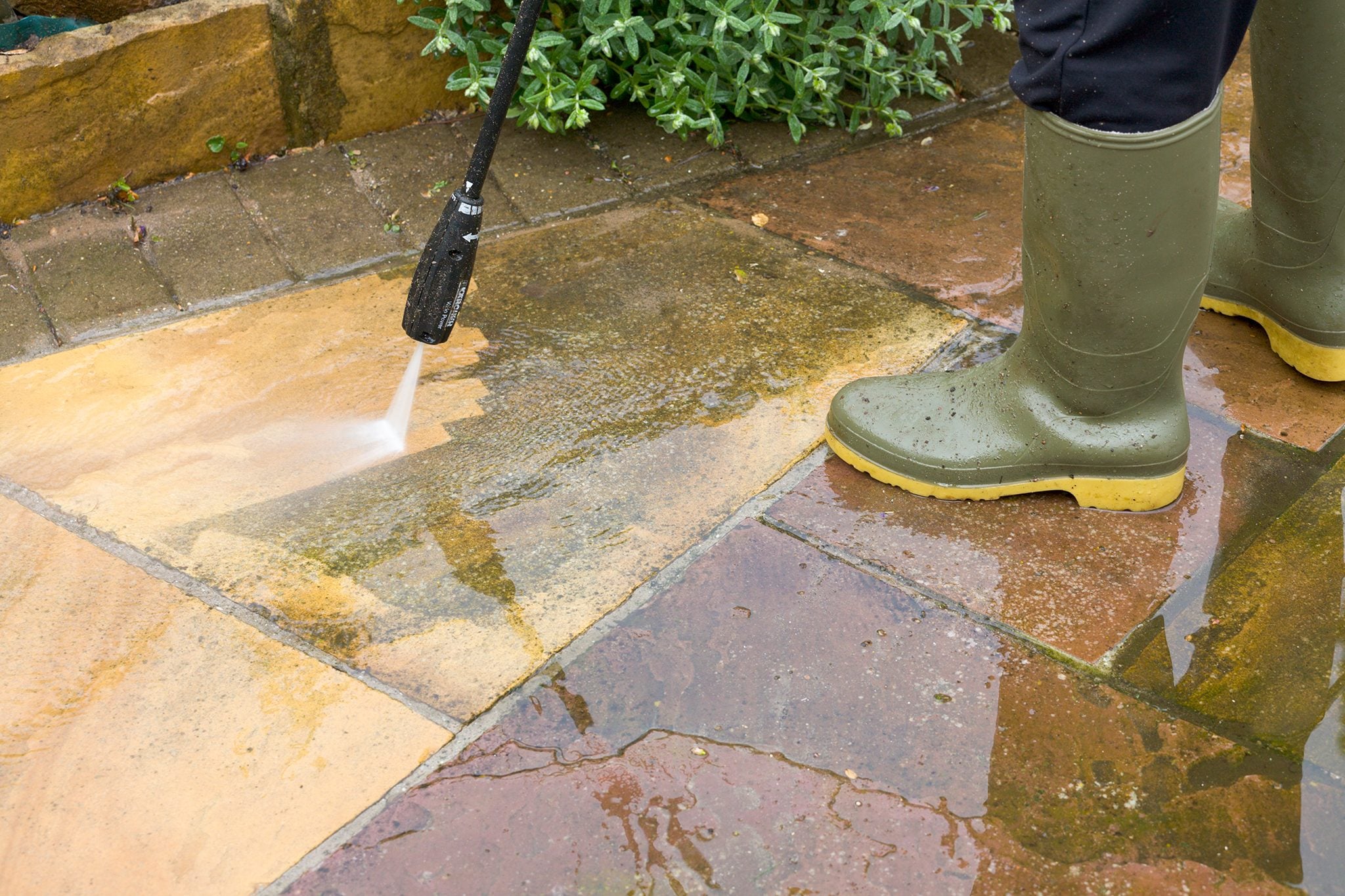 Cleaning patio with power washer