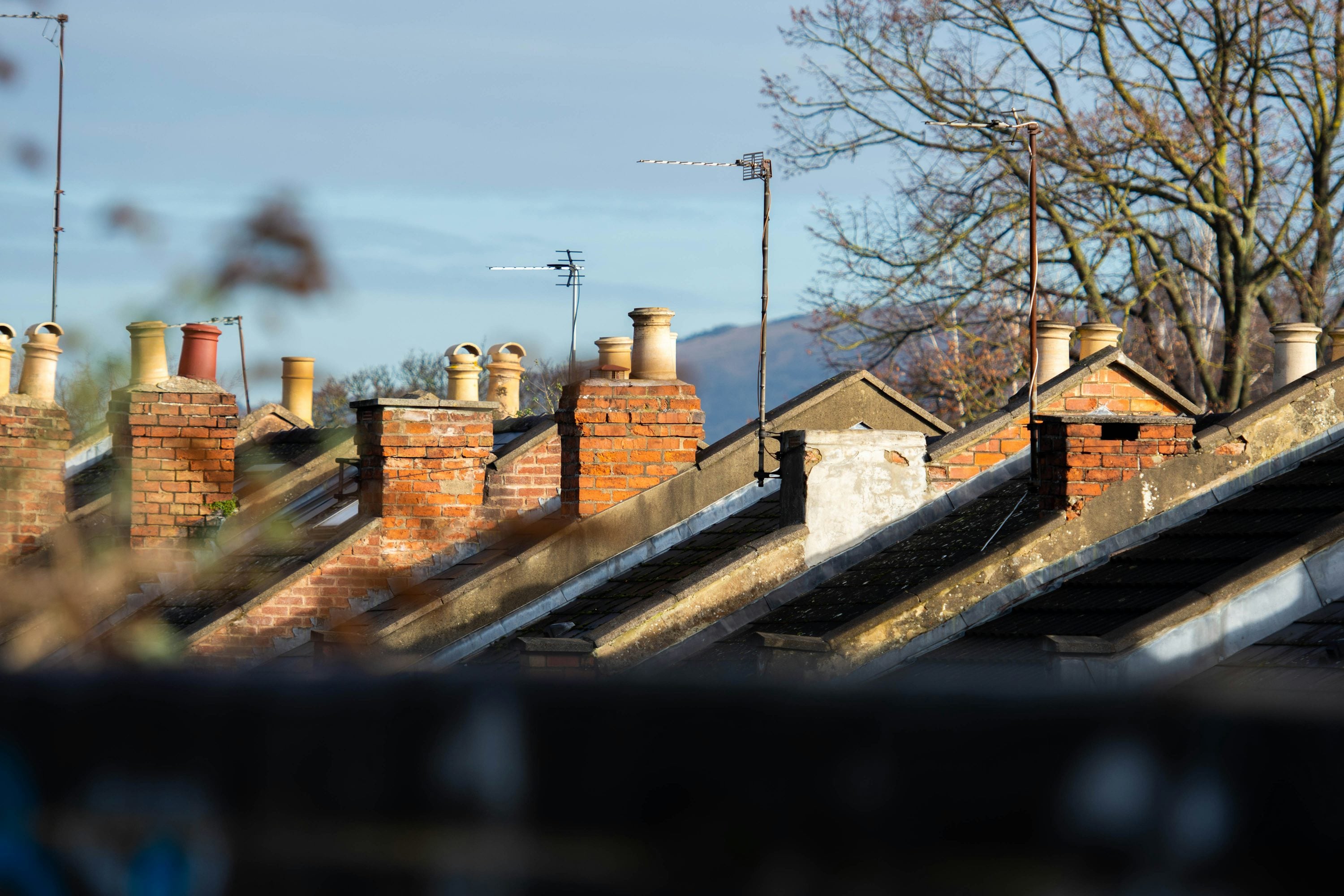 Row of chimney stacks on UK terraced houses