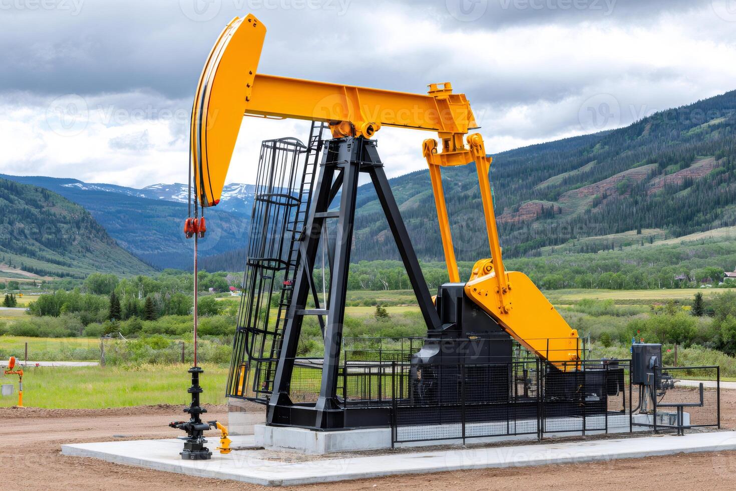 Oil pump jacks producing crude oil in a mountain valley
