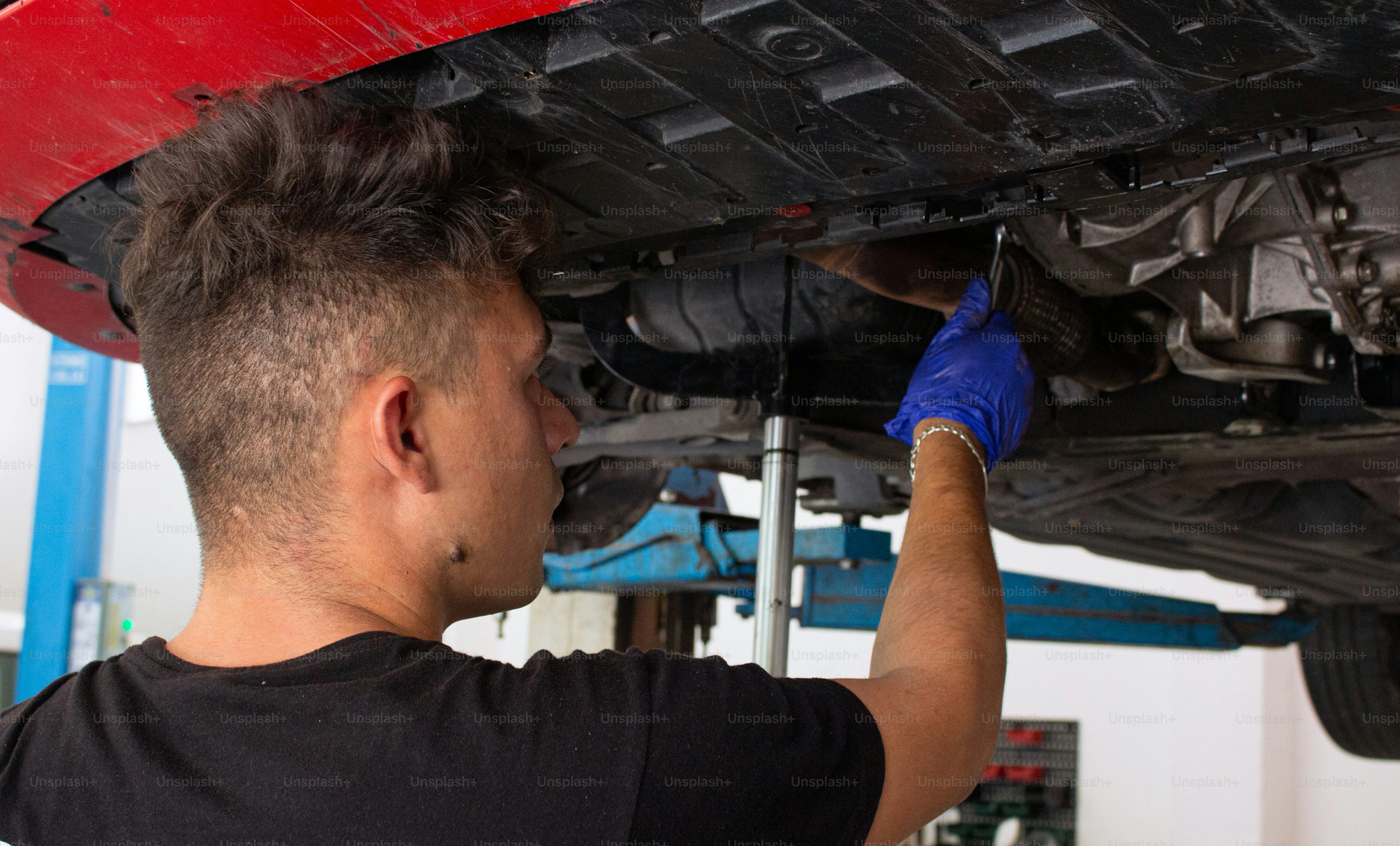 Mechanic performing undercarriage repair work