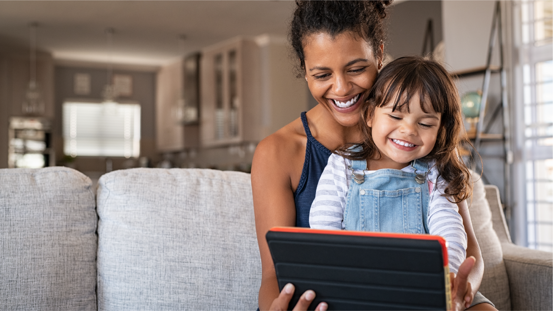 Parent and child looking at a computer together, representing the importance of digital safety awareness
